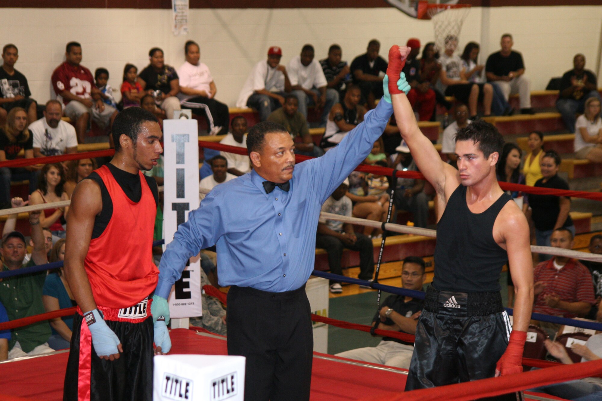 Above, referee Mike Walker raises the hand of James Barber, who won a unanimous decision over Army Reserve boxer Tim Berna. Barber is the reigning base champion.(Air Force photo by Becky Pilifant)