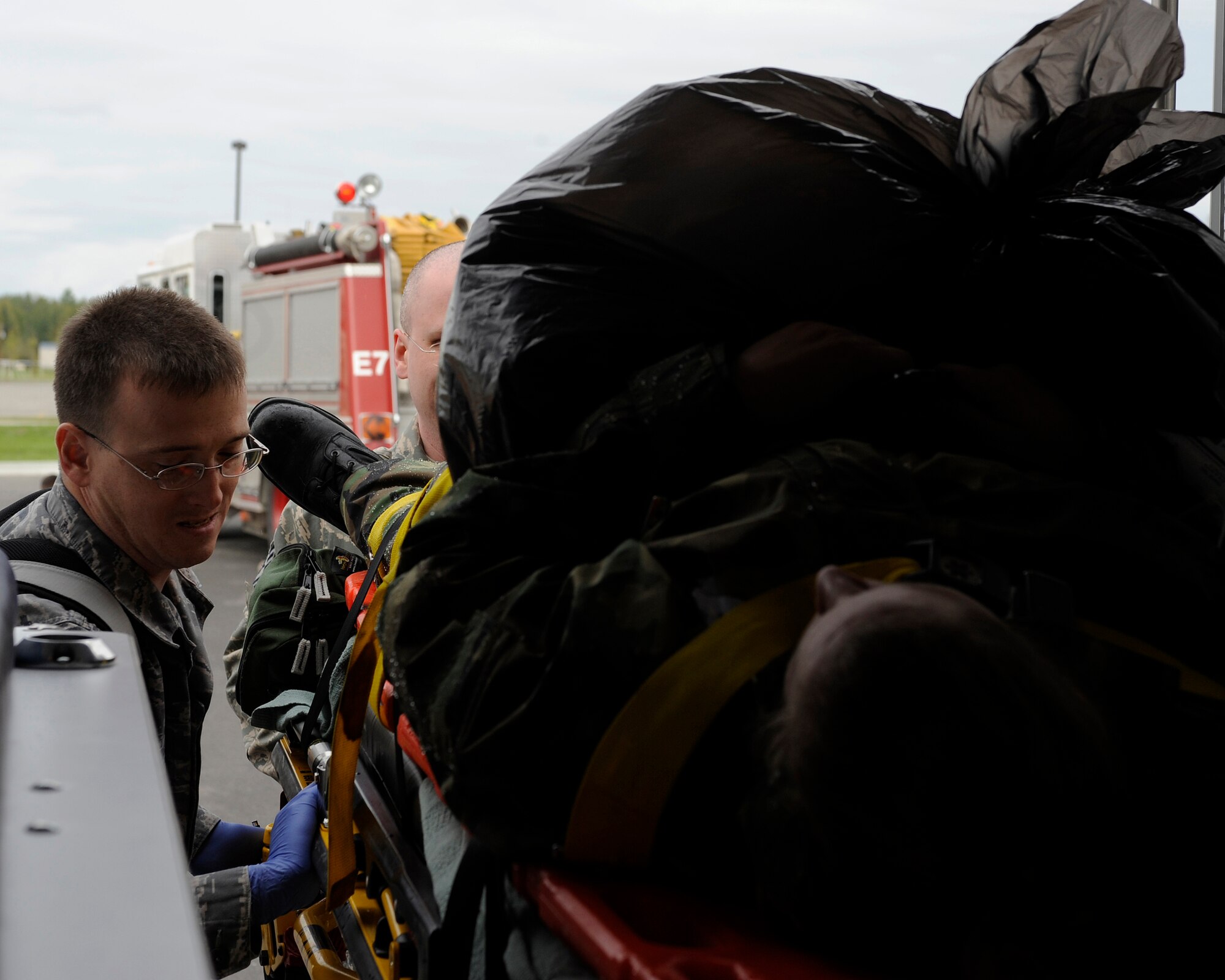 Medical specialists from the 354th Medical Group load a mock victim on to an ambulance Aug. 26, 2009, Eielson Air Force Base, Alaska. The Medical Group was spread out between two locations during the exercise requiring more emergency management skills to be utilized. (U.S. Air Force photo/Airman 1st Class Willard E. Grande II)