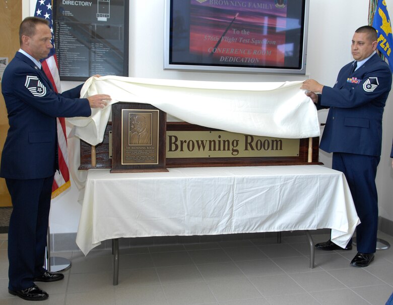VANDENBERG AIR FORCE BASE, Calif. --  Senior Master Sgt. Ronnie Leviner and Masetr Sgt. Jesus Medrano, both with the 576th Flight Test Squadron here, uncover the plaque and sign for the Browning Room during a ceremony here Aug. 21. The Browning Room is dedicated to retired Lt. Col. Jerry Browning, who served 30 years active duty and six years with the 576th FLTS. (U.S. Air Force photo/Airman 1st Class Andrew Lee)
