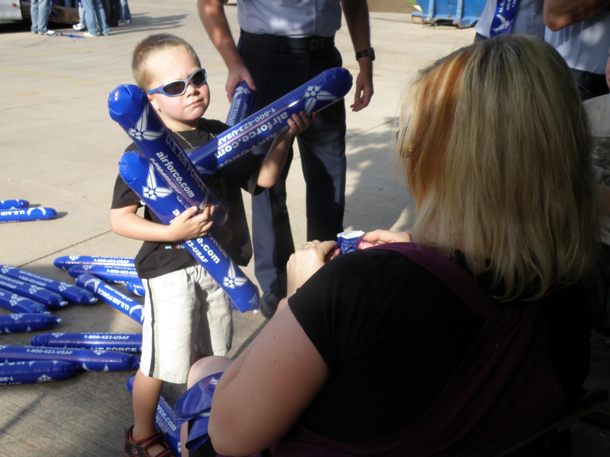 Five-year-old Jared Podolan helps his mom, Heather, gather Air Force Thundersticks prior to the Salt Lake Bees baseball game Aug. 22, at Spring Mobile Park, Salt Lake City, Utah. Preparation for the event was a family affair as 368th Recruiting Squadron members like Master Sgt. James Podolan, A-Flight chief, enlisted the help of their loved ones to fill and hand out the thundersticks to fans. More than 17,000 people attended the Air Force Night game. (U.S. Air Force photo/Christa D’Andrea))