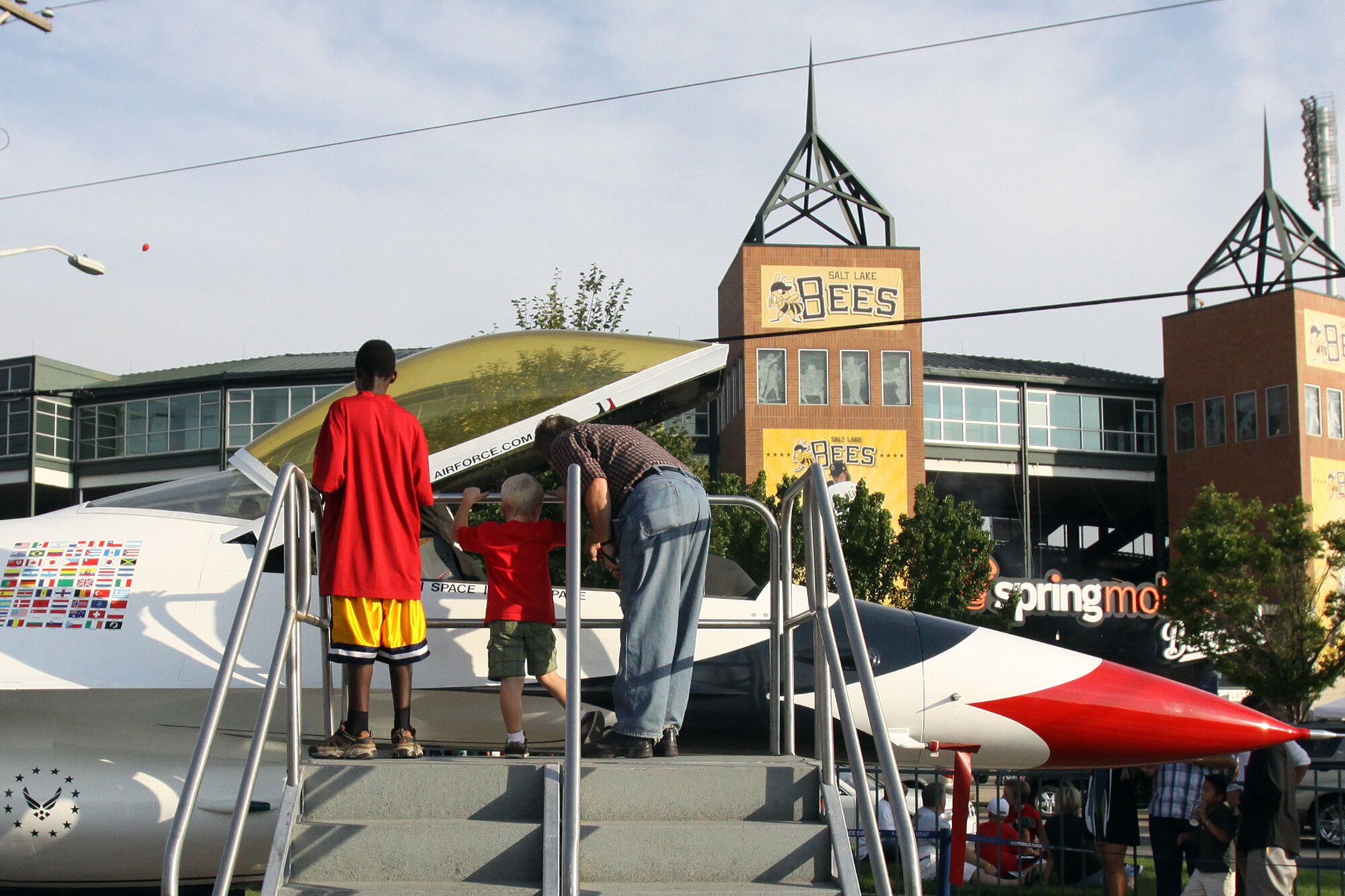 Fans get a close-up look at an F-16 Fighting Falcon prior to the Salt Lake Bees baseball game Aug. 22, at Spring Mobile Park, Salt Lake City, Utah. The F-16, painted like a U.S. Air Force Thunderbird, is part of the Air Force’s Engage Tour. The Engage Tour gives spectators the opportunity to learn more about the Air Force through interactive activities such as video games and an extreme equilibrium ride. (Salt Lake Bees photo/Brent Asay)