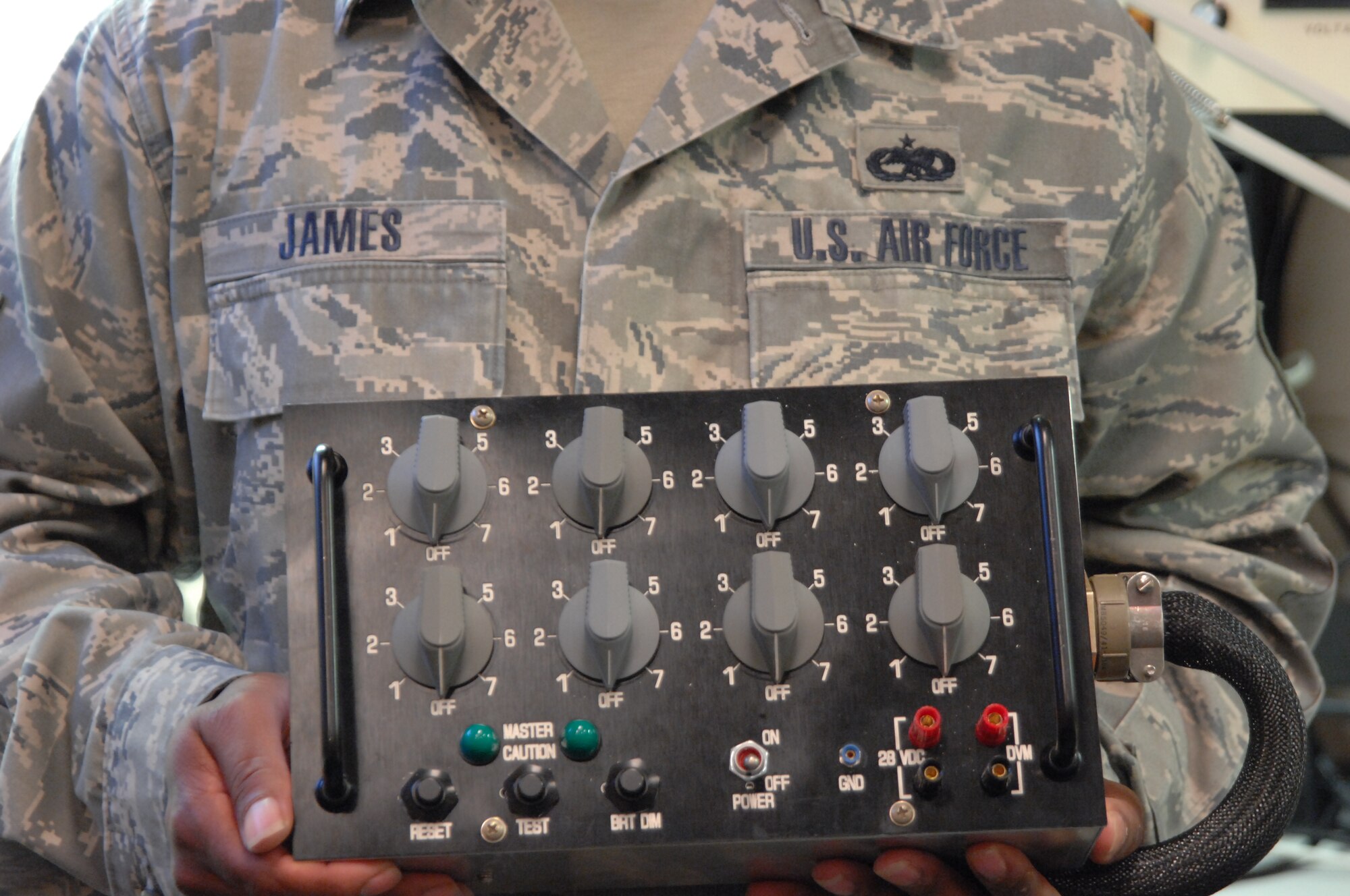 MOODY AIR FORCE BASE, Ga. -- Tech. Sgt. Waltress James, an Air Force Repair Enhancement Program technician here at Moody, holds a caution annunciator test set here Aug. 26. He built the test set from scratch over the course of three months. The set is used in A-10C Thunderbolt II aircraft and gives pilots a visual display of indicators, including engine temperature and navigational mode. (U.S. Air Force photo by Airman 1st Class Brigitte Brantley)