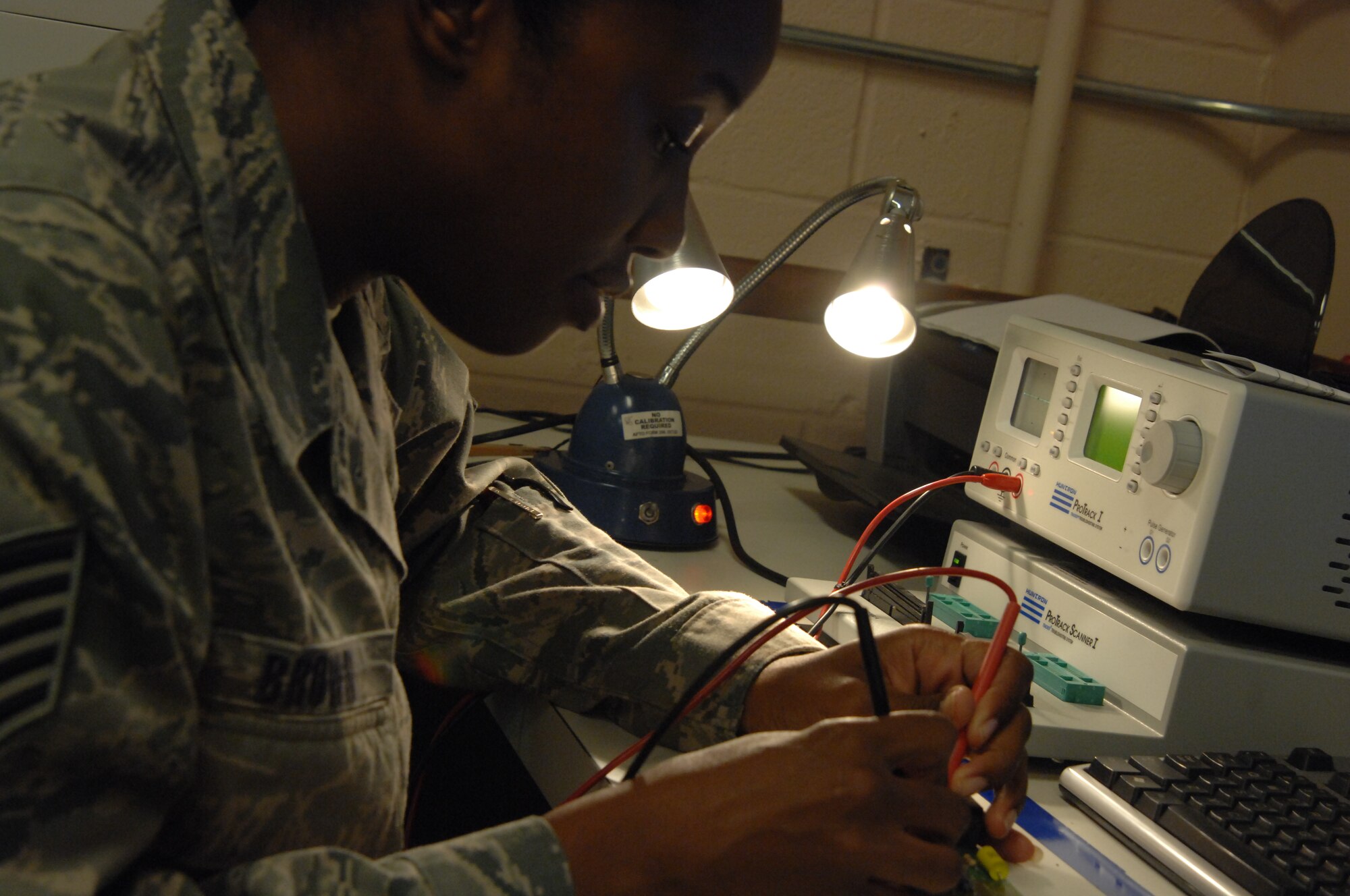 MOODY AIR FORCE BASE, Ga. -- Tech. Sgt. Lacrystal Brown, an Air Force Repair Enhancement Program technician at Moody, checks a circuit card with a HUNTRON computer here Aug. 26. Each component of a circuit card has a separate electronic signature and is checked for efficient performance through this computer. (U.S. Air Force photo by Airman 1st Class Brigitte Brantley)
