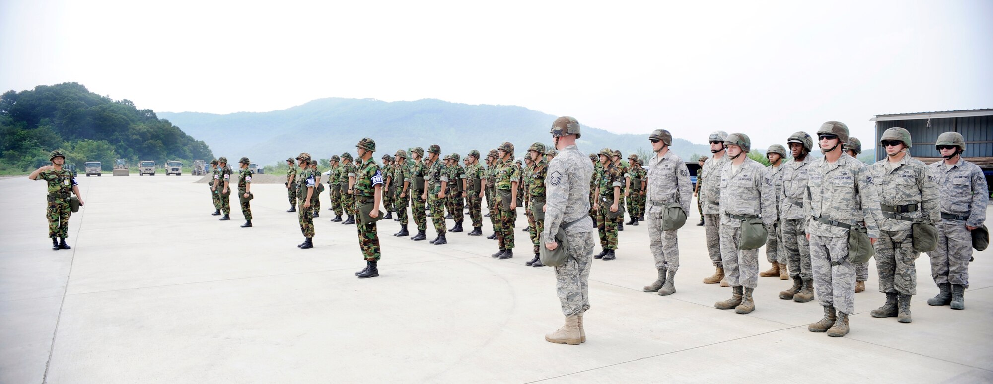 Airmen from the 51st Civil Engineer Squadron stand in formation before participating in a joint combined rapid runway repair training exercise with Airmen from the South Korean air force's 19th Tactical Fighter Wing and 91st Air Civil Engineer Group Aug. 19 at Jungwon Air Base, South Korea. (U.S. Air Force photo/Senior Airman Stephenie Wade) 