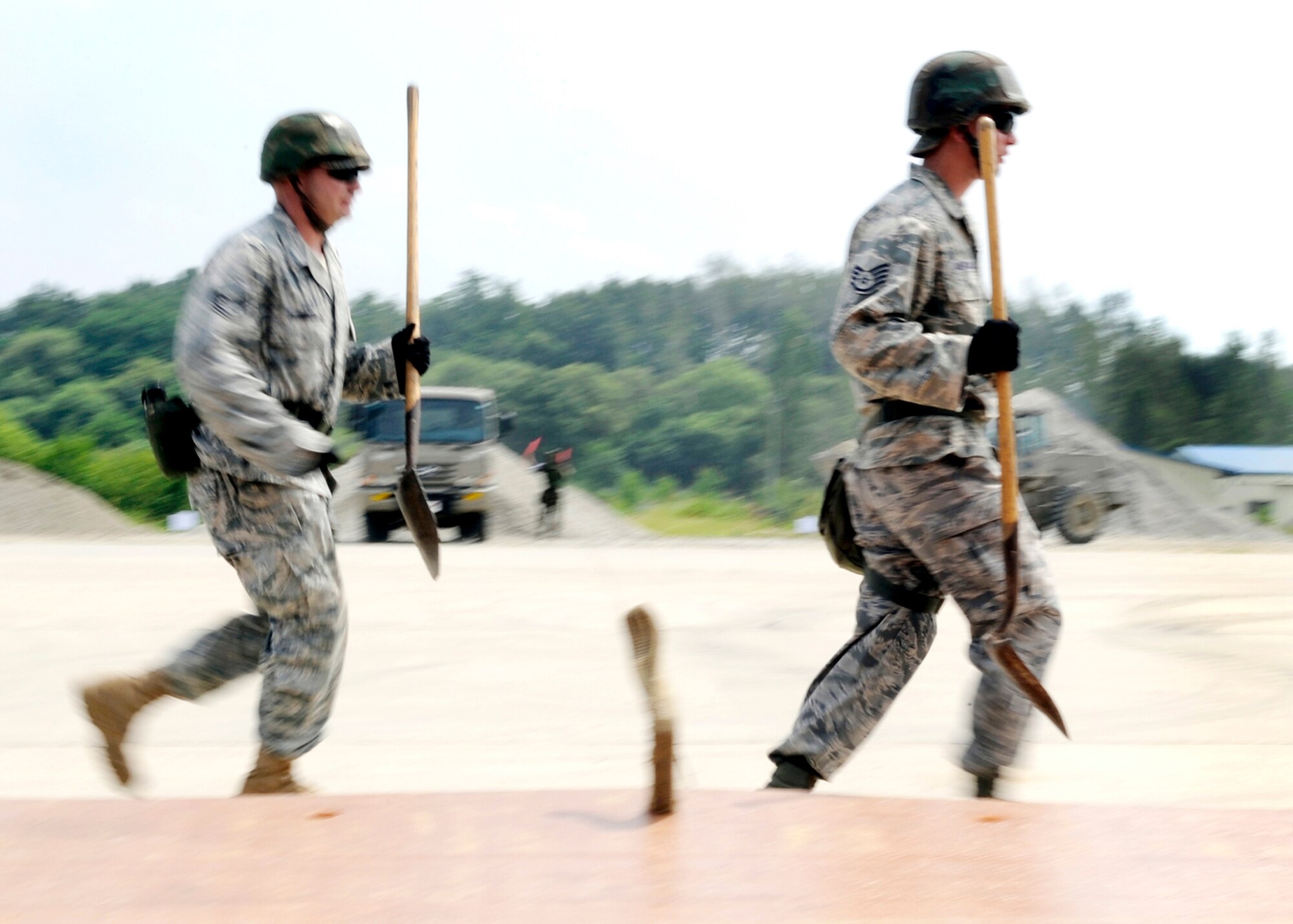 Tech. Sgt. Robert Barnett (left) and Staff Sgt. Tony Anderson run to assist in moving of a folded fiberglass mat Aug. 19 at Jungwon Air Base, South Korea. The Airmen are a part of a joint combined rapid runway repair training exercise with Airmen from the South Korean air force's 19th Tactical Fighter Wing and 91st Air Civil Engineer Group. Sergeants Anderson and Barnett are assigned to the 51st Civil Engineer Squadron at Osan Air Base, South Korea. (U.S. Air Force photo/Senior Airman Stephenie Wade)
