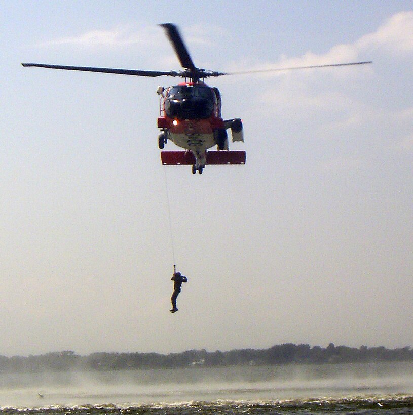 LANGLEY AIR FORCE BASE, Va. --  A MH-60J "Jayhawk" rescue helicopter hoists a Survival, Evasion, Resistance and Escape student from the water during survival training here Aug. 25.  The survival training, conducted by SERE specialists, teaches students how to survive if they egress over water. The course also covers proper signaling, desalinating water, finding sustenance and how to properly release from a parachute drag. Pilots are required to complete water survival training every three years. (U.S. Air Force photo/Senior Airman Zachary Wolf)