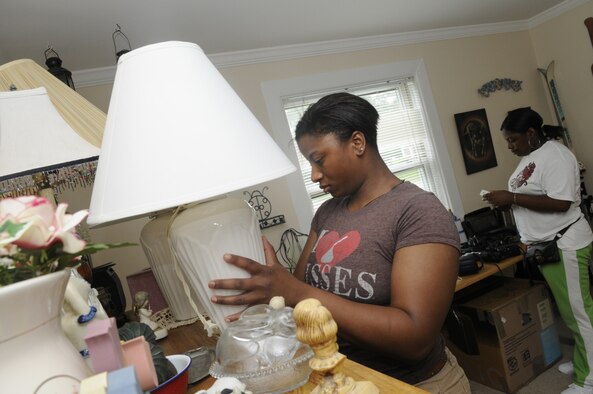Kecia Hardwick considers a pair of lamps for her use at the Airman's Attic August 19. U. S. Air Force photo by Sue Sapp