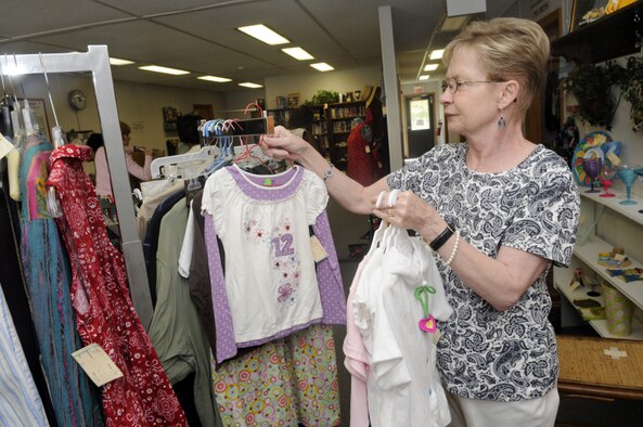 Margaret Donohoe, Thrift Shop volunteer, puts newly arrived clothes out on the floor for sale. U. S. Air Force photo by Sue Sapp