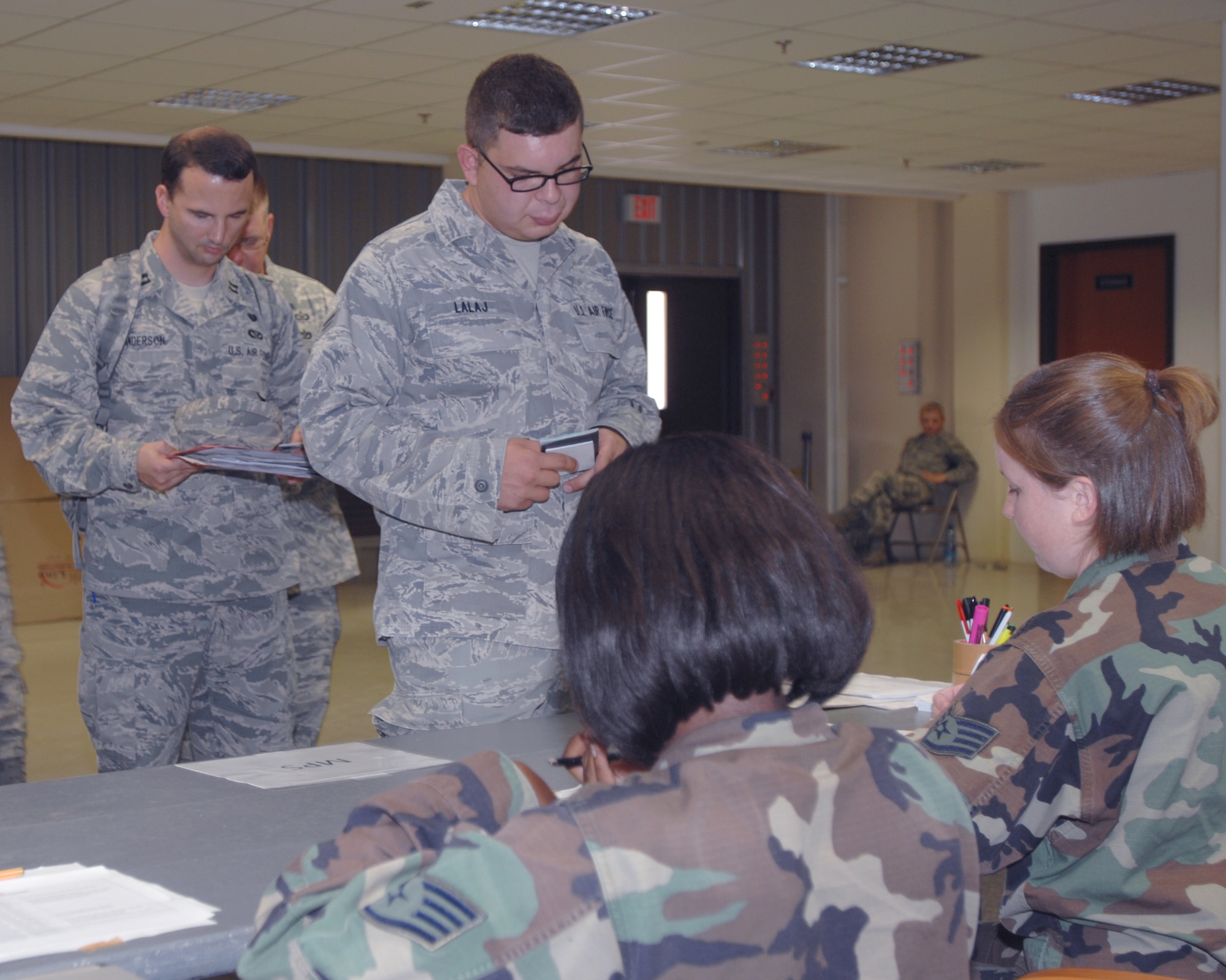 Airman 1st Class Besmir Lalaj, 39th  Communications Squadron, waits as military personnel section Airmen reviews his mobility folder during a deployment exercise, Wednesday, Aug. 26, 2009 , Incirlik Air Base, Turkey.  Participants from each  squadron  packed a duffel bag of uniforms and personal hygiene items before processing to deploy to a fictitious location. (U.S. Air Force photo/Staff Sgt. Lauren Padden)