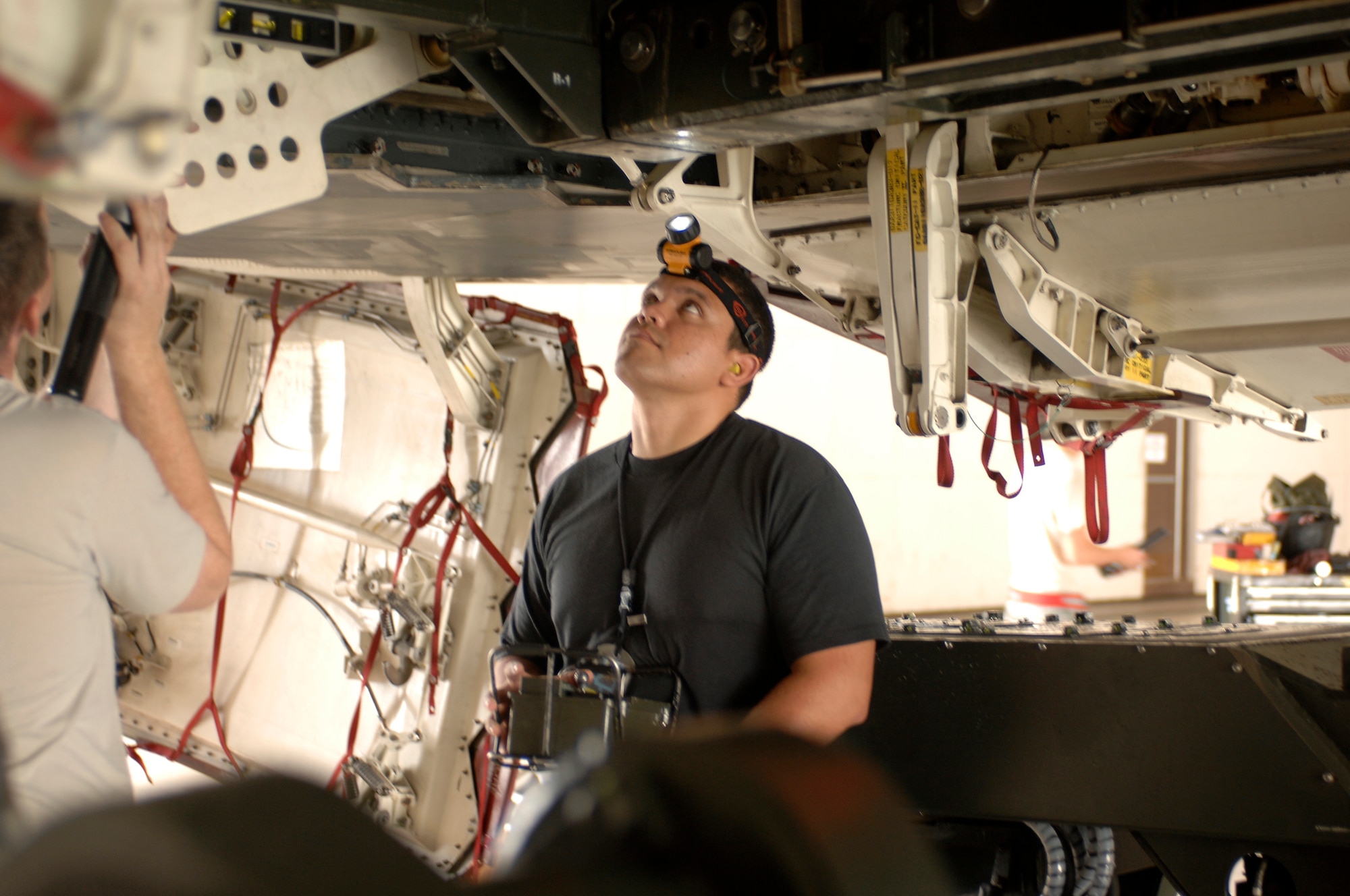 WHITEMAN AIR FORCE BASE, Mo. - Staff Sgt. Juan Molina, 509th Aircraft Maintenance Squadron, observes a weapons trailer position Aug. 17 as he raises it into the bomb bay of a B-2 Spirit. Mock bombs were loaded on the B-2 as part of the 72nd Test and Evaluation Squadron Combat Sledgehammer. (U.S. Air Force photo/Staff Sgt. Jason Barebo)