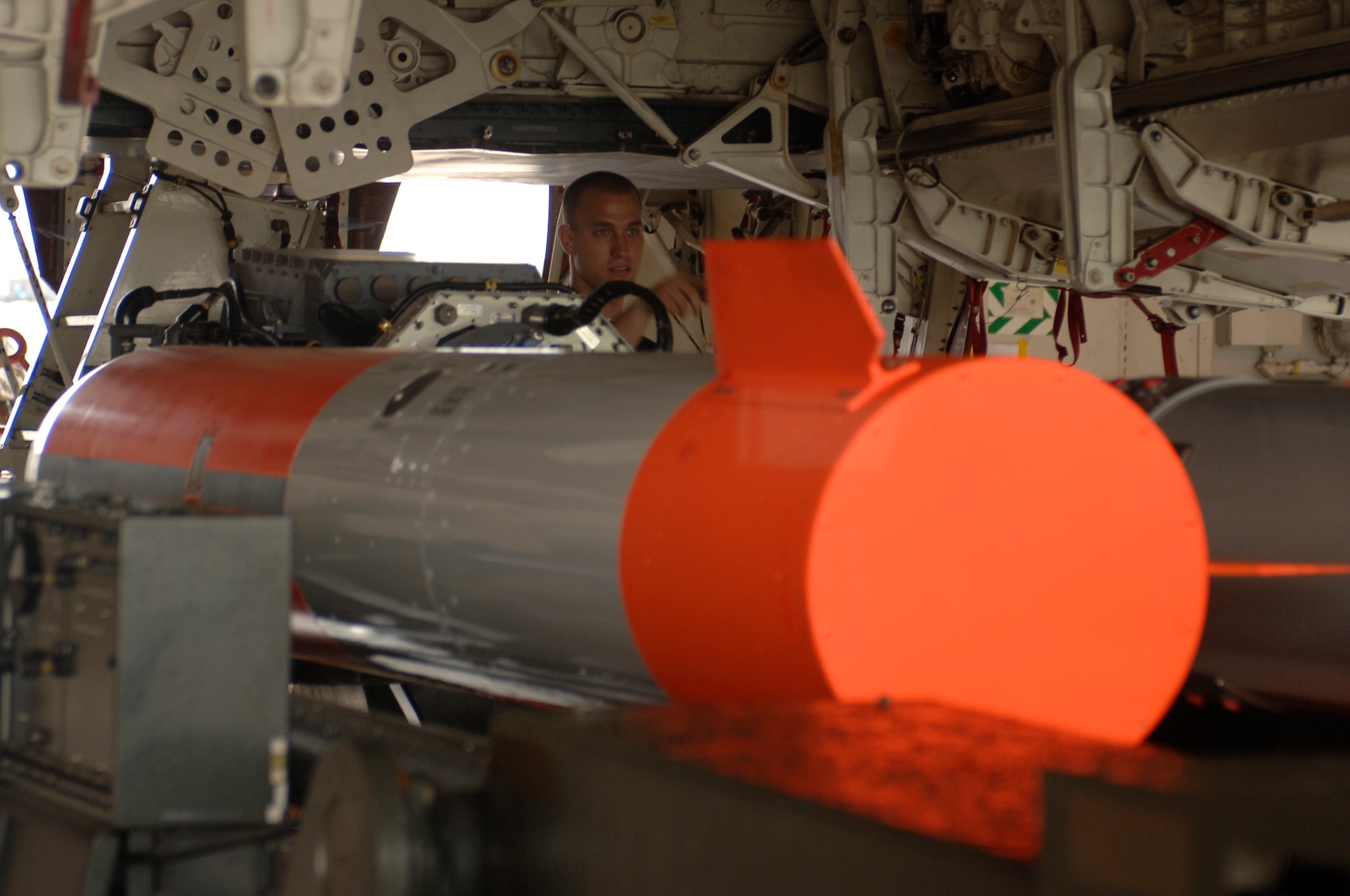 WHITEMAN AIR FORCE BASE, Mo. - Airman 1st Class Gregory Lowe, 509th Aircraft Maintenance Squadron, directs Staff Sgt. Juan Molina, 509th Aircraft Maintenance Squadron, to adjust a weapons load trailer Aug. 17 to ensure proper position. The weapons load is part of the 72nd Test and Evaluations Squadron's Combat Sledgehammer. (U.S. Air Force photo/Staff Sgt. Jason Barebo)