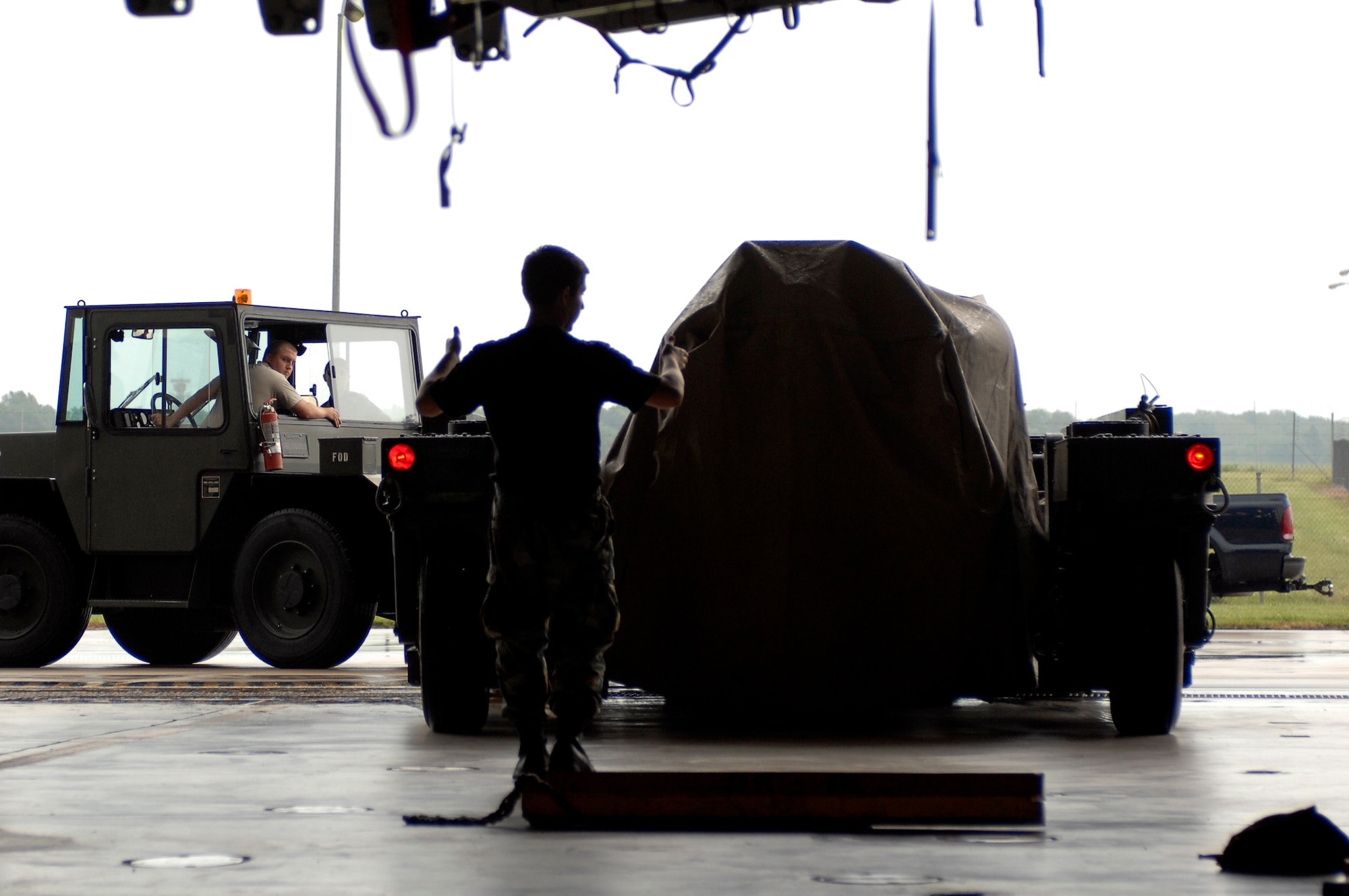 WHITEMAN AIR FORCE BASE, Mo. - Members of the 509th Aircraft Maintenance Squadron back a weapons load trailer into a B-2 dock Aug. 17 in preperation to load mock bombs into a B-2 Spirit bomb bay. The weapons load is par tof the 72nd Test and Evaluation Squadron's Combat Sledgehammer. (U.S. Air force photo/Staff Sgt. 
