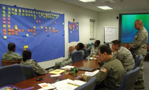Members of the Air Force Smart Operations for the 21st Century team work to improve the Family Care Program during a meeting held here recently. The AFSO21 team helped create solid and workable solutions for the 315th Airlift Wing Family Care Program and provided a means to measure and track progress with goals and follow-up dates. The team members are with the 315 AW. (Courtesy photo)
