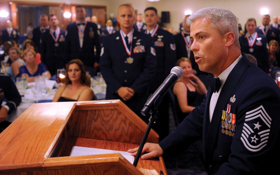 Chief Master Sgt. Robert Sealey, 89th Airlift Wing command chief master sergeant, administers the senior non-commissioned officers induction creed during the Team Andrews SNCO induction ceremony at The Club at Andrews July 17. The SNCOs induction ceremony was held to recognize individuals who were selected for master sergeant promotion and transition to the senior leadership level. (U.S. Air Force photo by Senior Airman Steven Doty)