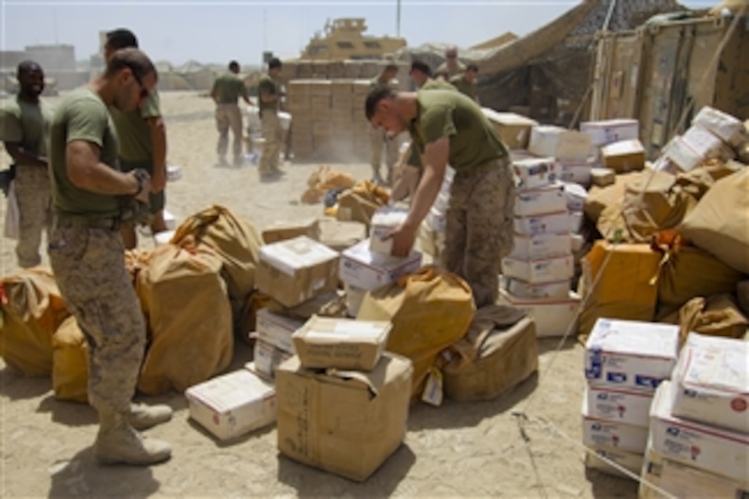 U.S. Marines with 1st Battalion, 5th Marine Regiment sort mail at Patrol Base Jaker in the Nawa district, Helmand province, Afghanistan, on Aug 23, 2009.  The 1st Battalion is deployed with Regimental Combat Team 3 to conduct counterinsurgency operations in partnership with Afghan security forces in southern Afghanistan.  