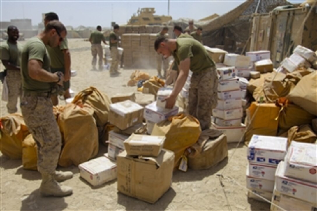 U.S. Marines with 1st Battalion, 5th Marine Regiment sort mail at Patrol Base Jaker in the Nawa district, Helmand province, Afghanistan, on Aug 23, 2009.  The 1st Battalion is deployed with Regimental Combat Team 3 to conduct counterinsurgency operations in partnership with Afghan security forces in southern Afghanistan.  