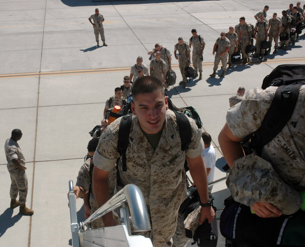 Approximately 90 Marines from Marine Attack Squadron 513 and Marine Aviation Logistics Squadron 13 board a plane bound for Japan Aug. 27, 2009, on the flight line at the Marine Corps Air Station in Yuma, Ariz. While on deployment the squadron will join the 31st Marine Expeditionary Unit and is scheduled to participate in exercises Ryuku Warrior, Talisman Saber and Wolmi-Do Fury. Eight of the VMA-513’s AV-8B Harriers and pilots left for Japan Aug. 9, 2009. The remainder of VMA-513 is scheduled to deploy with the 11th MEU in September.