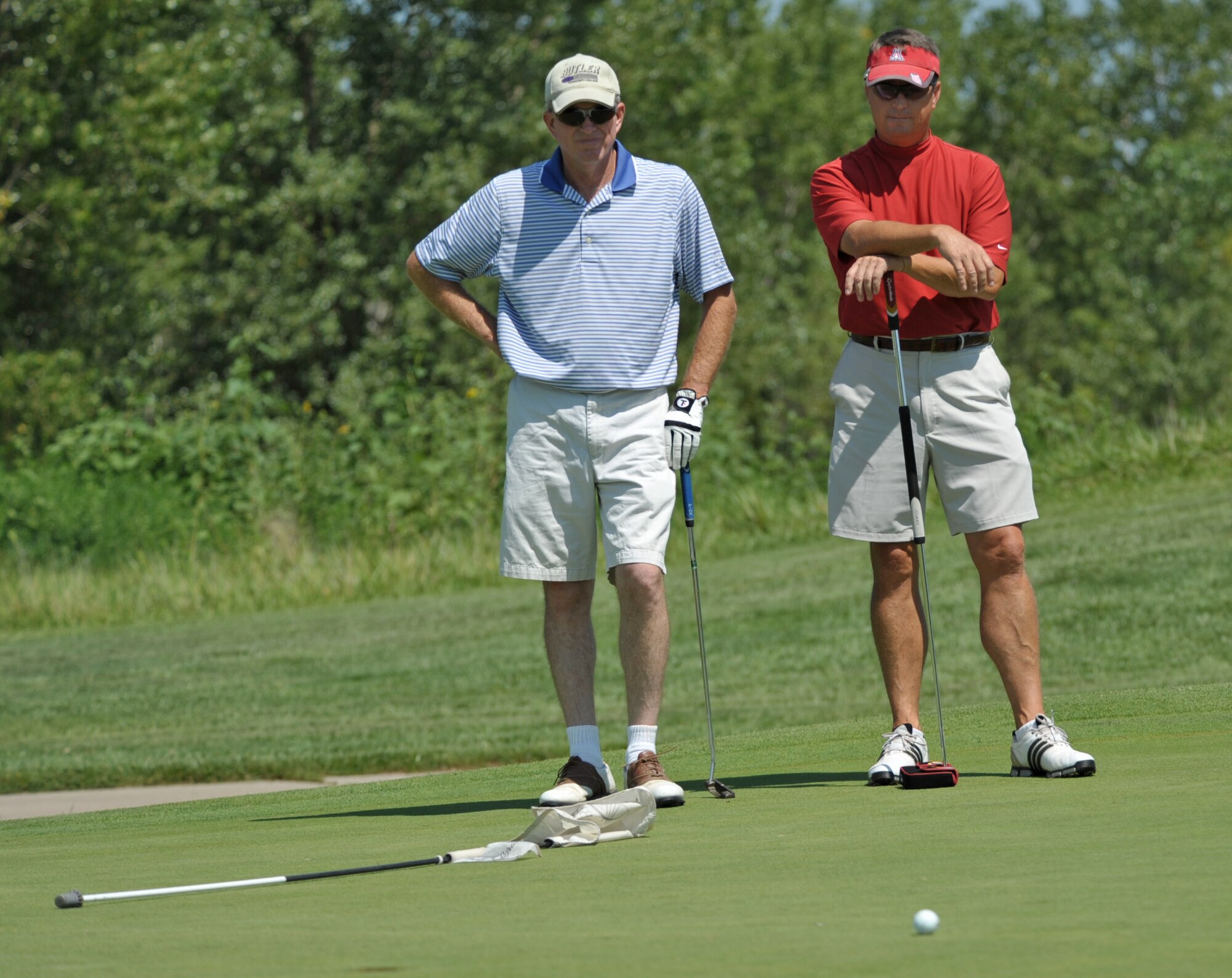 Lt. Col. Greg Harney and Col. (retired) Ron Johnston calmly wait for their turn to putt during an intramural championship golf match at Auburn Hills Golf Course, Wichita, Kan. The two easily won the match-play contest in 11 holes and earned the 931st Air Refueling Group its second consecutive McConnell Air Force Base Intramural Golf Championship. (U.S. Air Force photo/Tech. Sgt. Jason Schaap)