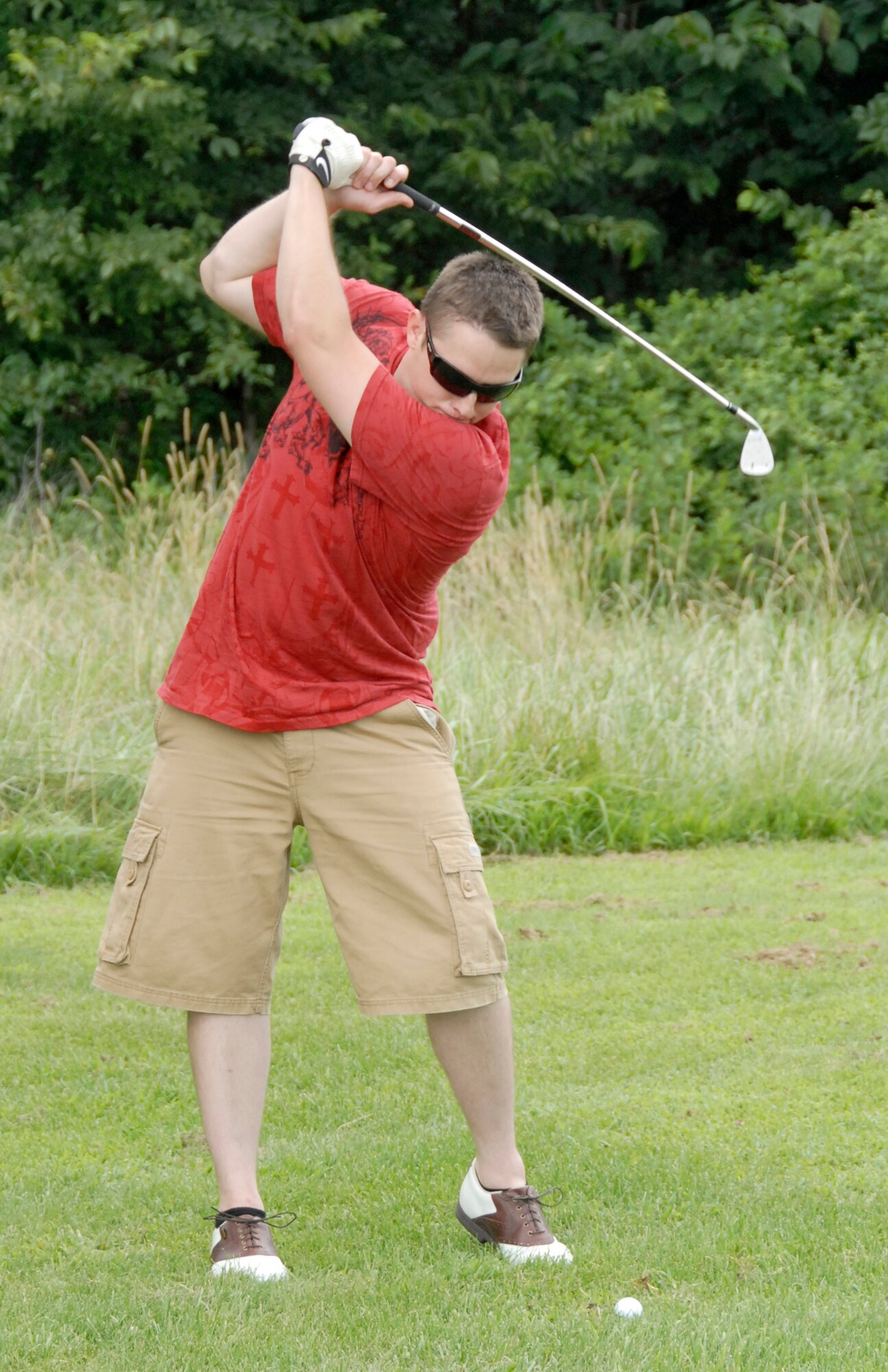 Staff Sgt. Cody Crichton, 442nd Maintenance Squadron, makes a shot from the fairway at hole number four at the Royal Oaks Golf Course, Whiteman Air Force Base, Mo., Aug. 1.  Sergeant Crichton participated in a charity golf tournament to benefit the Wright Flight program.  Wright Flight is a program to teach kids self determination and goal setting using aviation as its theme.  Many members of the 442nd Fighter Wing volunteer their time for the Wright Flight program through the wing's Human Resources Development Council.  The tournament raised more than $1,500 for the program. The 442nd is an Air Force Reserve wing based at Whiteman. (U.S. Air Force photo/Tech. Sgt. John Vertreese)