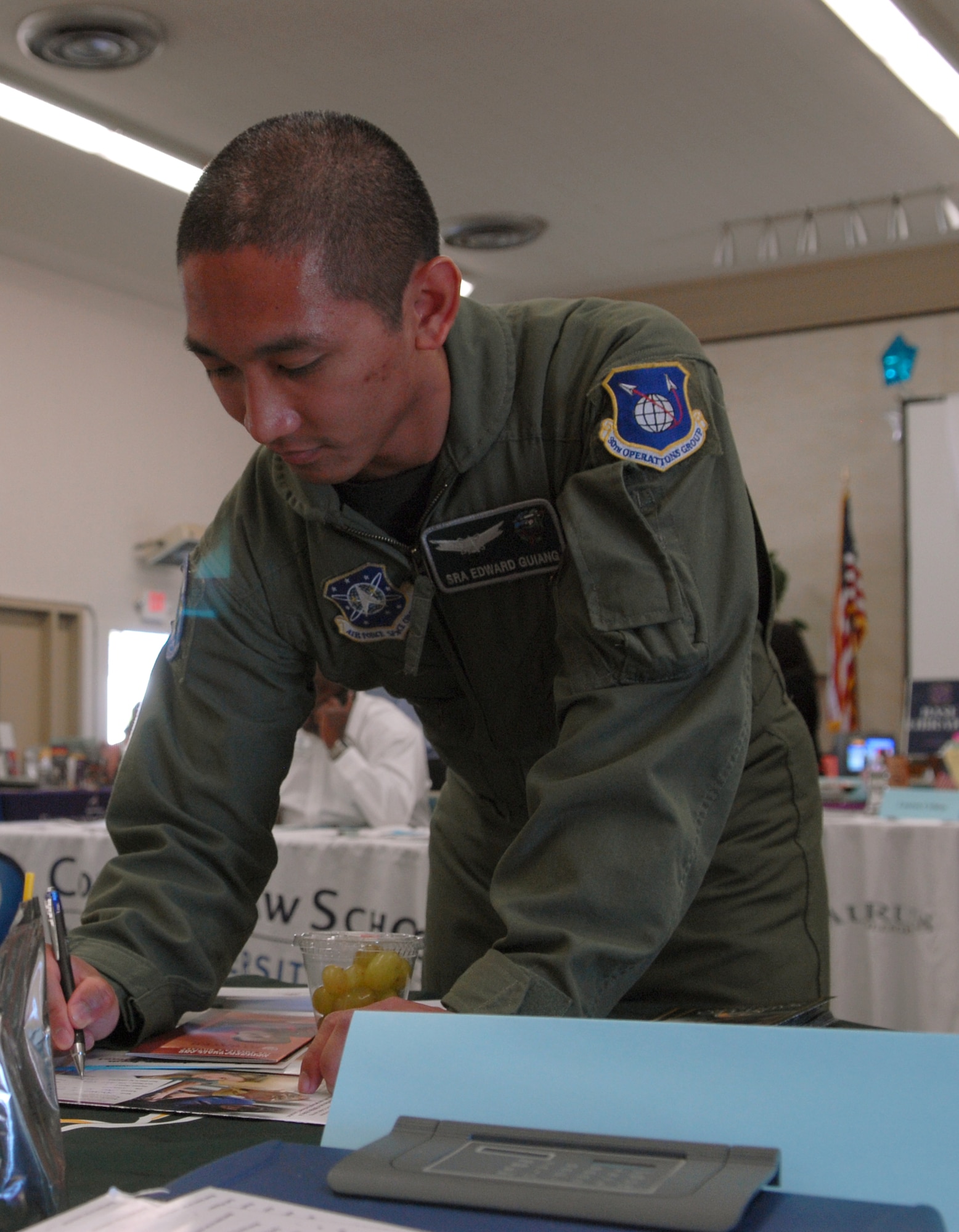 VANDENBERG AIR FORCE BASE, Calif. -- A Saint Leo University  representative explains the school’s academic programs to Senior Airman Edward Guiang, of the 30th Operations Group, at the Education Fair here Aug. 27. More than 200 Airmen and civilians attended the annual event. (U.S. Air Force photo/Airman 1st Class Angelina DellaRocco-Rukavina)