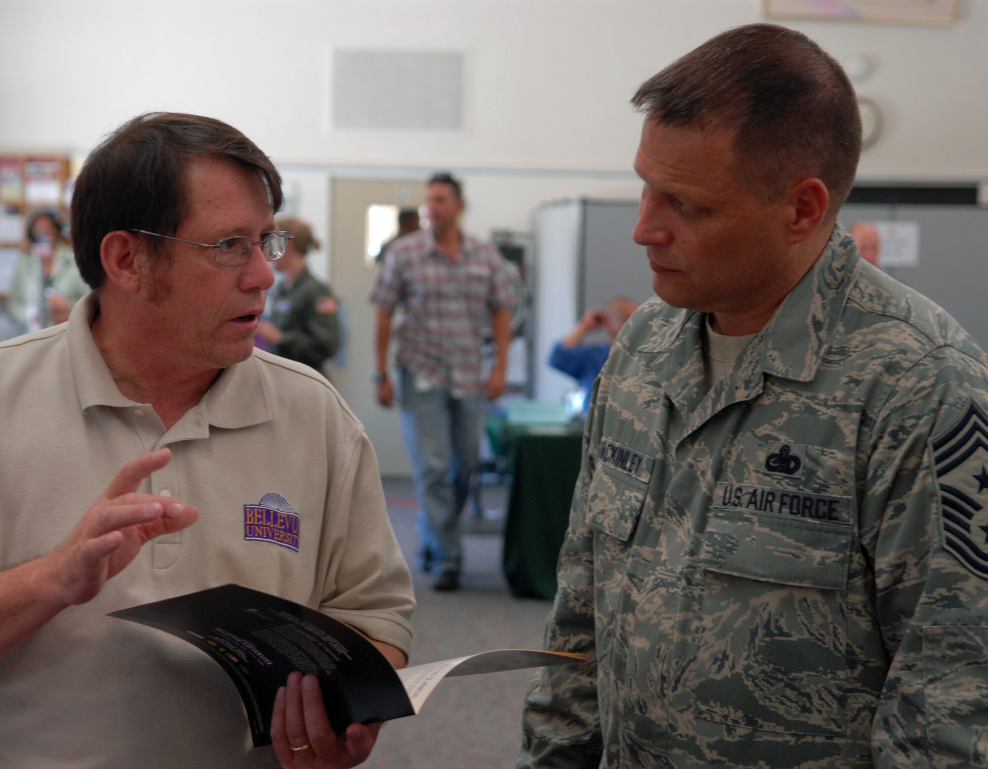 VANDENBERG AIR FORCE BASE, Calif. -- Taking advantage of the 32 college representatives present, Chief Master Sgt. Jim MacKinley, the 14th Air Force command chief, speaks with a representative during Vandenberg’s Education Fair to obtain information about the programs offered by Bellevue University. The fair took place at Vandenberg’s Education Center on Aug. 27, with more than 200 Airmen and civilians attending. (U.S. Air Force photo/Airman 1st Class Angelina DellaRocco-Rukavina)