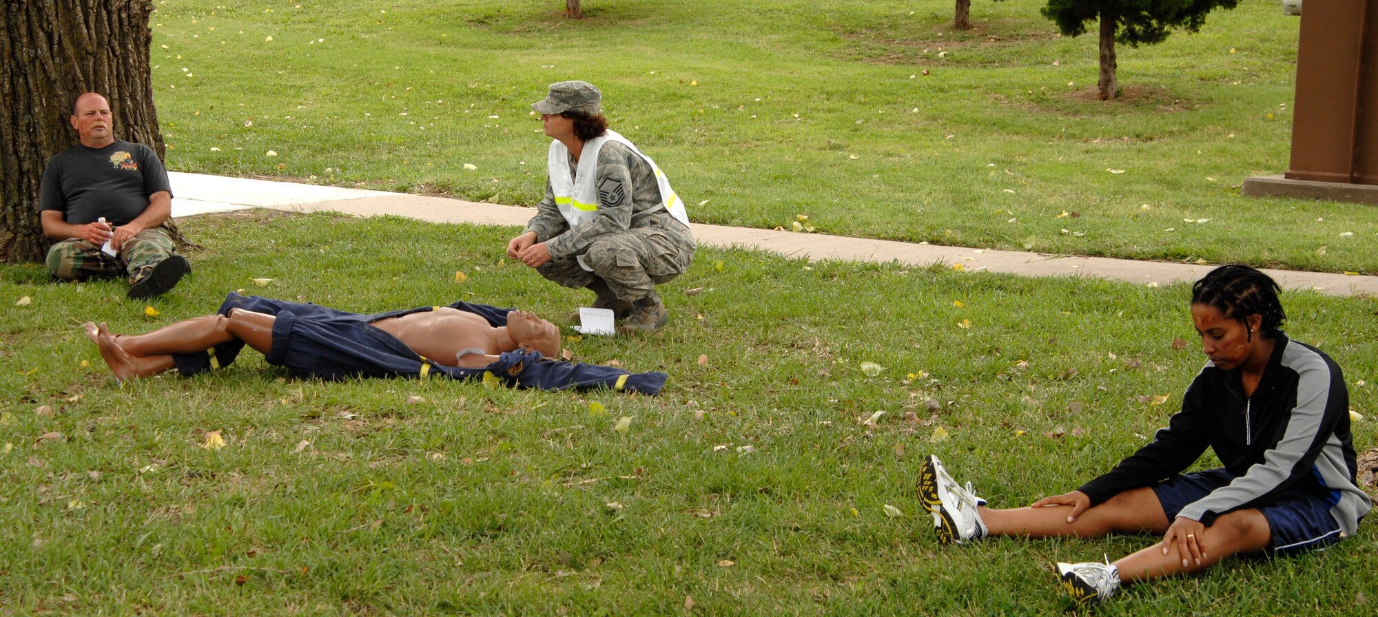 Tech. Sgt. Justin Veik, left, 184th Refueling Squadron, and Airman 1st Class Bethanya Abebe, right, 22nd Mission Support Group, act as blister agent victims waiting for medical assistance during a major accident response exercise at McConnell AFB, Kan., Aug. 27. Master Sgt. Janice Faught, 22nd Medical Operations Squadron evaluates the scenario while overseeing the exercise. The MARE tested Team McConnell’s ability to handle crisis situations involving injuries and casualties. (U.S. Air Force photo/Senior Airman Laura Suttles)