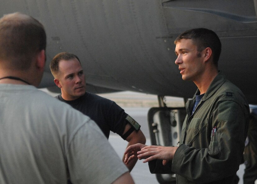 NELLIS AIR FORCE BASE, Nev. -- Staff Sgt. Sean Adkins, 2d Maintenance Squadron, listens as Capt. Warren Carroll, 20th Bomb Squadron, conducts a post flight maintenance brief with maintainers after arriving at Nellis Air Force Base, Nev., Aug. 21 for his first Red Flag. (U.S. Air Force photo by Staff Sgt. Sarah Stegman)