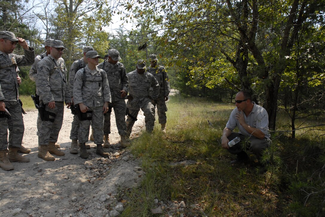 An EOD instructor, Mr. David Leventhal, shows security forces students what signs to look for to detect an IED placed on their convoy route during a training exercise on a Fort Dix range, August 26, 2009, conducted by the 421st Combat Training Squadron hosted by the U.S. Air Force Expeditionary Center, Joint Base McGuire-Dix-Lakehurst, N.J. (U.S. Air Force Photo/Tech. Sgt. Paul R. Evans)