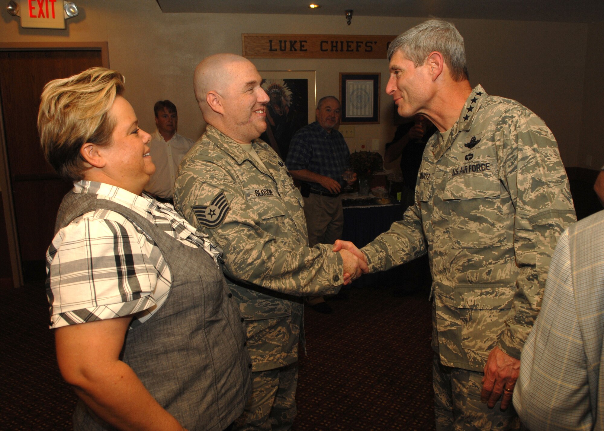 Tech. Sergeant Christopher "Matt" Slaydon, 56th Civil Engineer Squadron explosive ordinance disposal technician, and his wife Annette, greet Chief of Staff of the Air Force Gen. Norton Schwartz. Gen. Schwartz came to Luke Air Force Base, Aug. 27, 2009 to attend Sgt. Slaydon's retirement ceremony. (U.S. Air Force photo/Tech. Sgt. Jeffrey Wolfe)