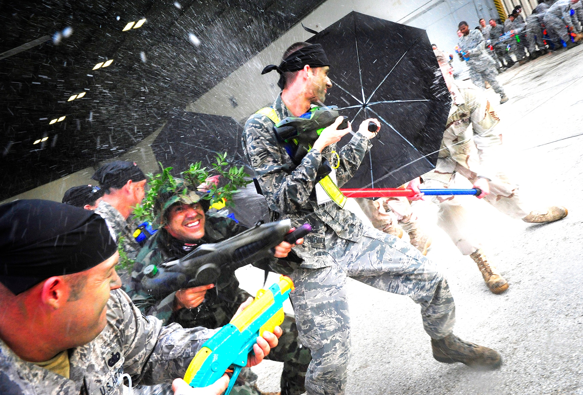 Airmen defend their simulated Defense Fighting Position with water guns during the Enlisted Combat Dining In here Aug. 21.  More than 350 service members participated in the event which was full of fun and camaraderie.  (U.S. Air Force photo by Airman First Class Rylan Albright/Released)