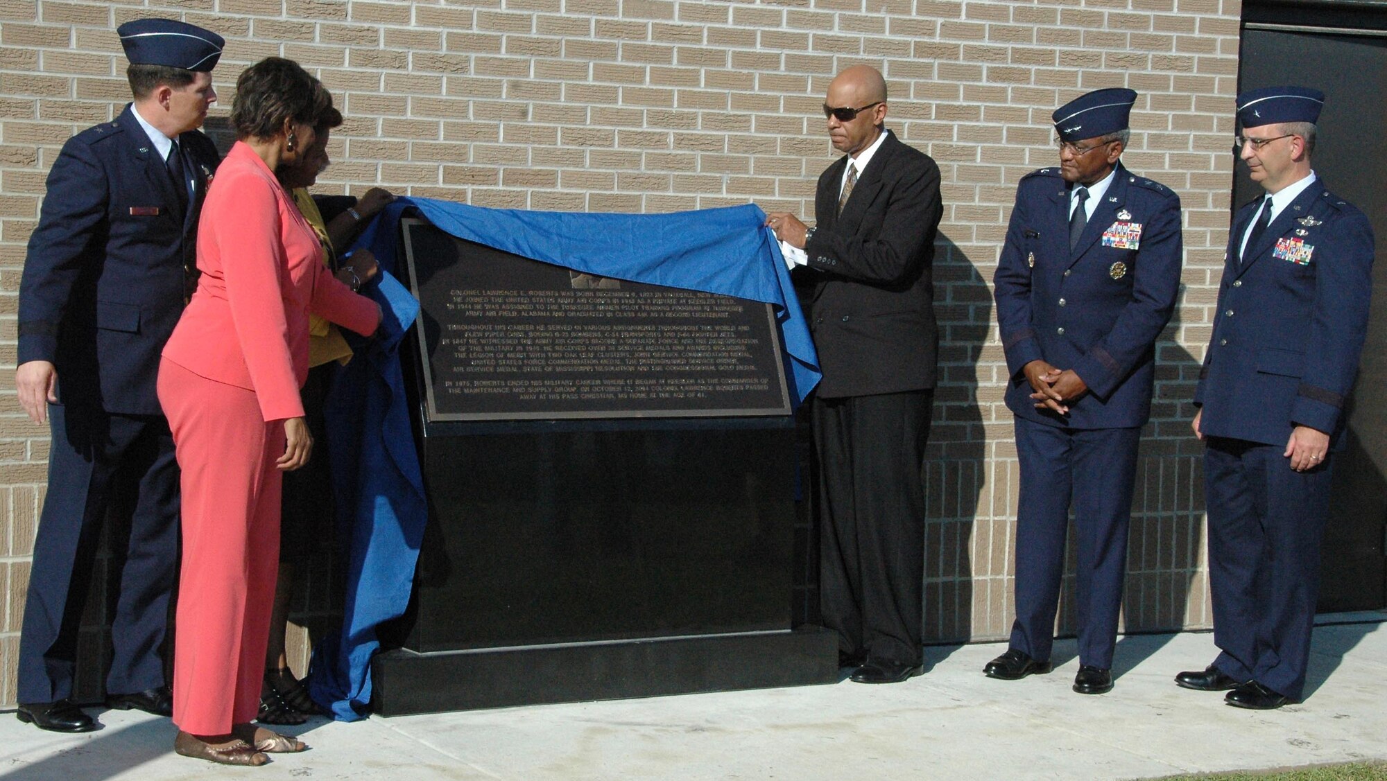 The 403rd Maintenance Group's new Consolidated Aircraft Maintenance Facility, named in honor of the late Col. (Ret.) Lawrence E. Roberts, was dedicated Aug. 28 at Keesler AFB, Miss. Above, members of Col. Roberts' family unveil a monument at the entrance of the facility.    