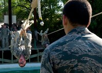 An Air Force Basic Military Training trainee holds on tightly as he crosses over the water pit. In addition to fitness training and military studies, BMT trainees are  taught foundational Air Force information including core values, customs andcourtesies, and basic policies and procedures. (U.S. Air Force photo/Benjamin Faske)