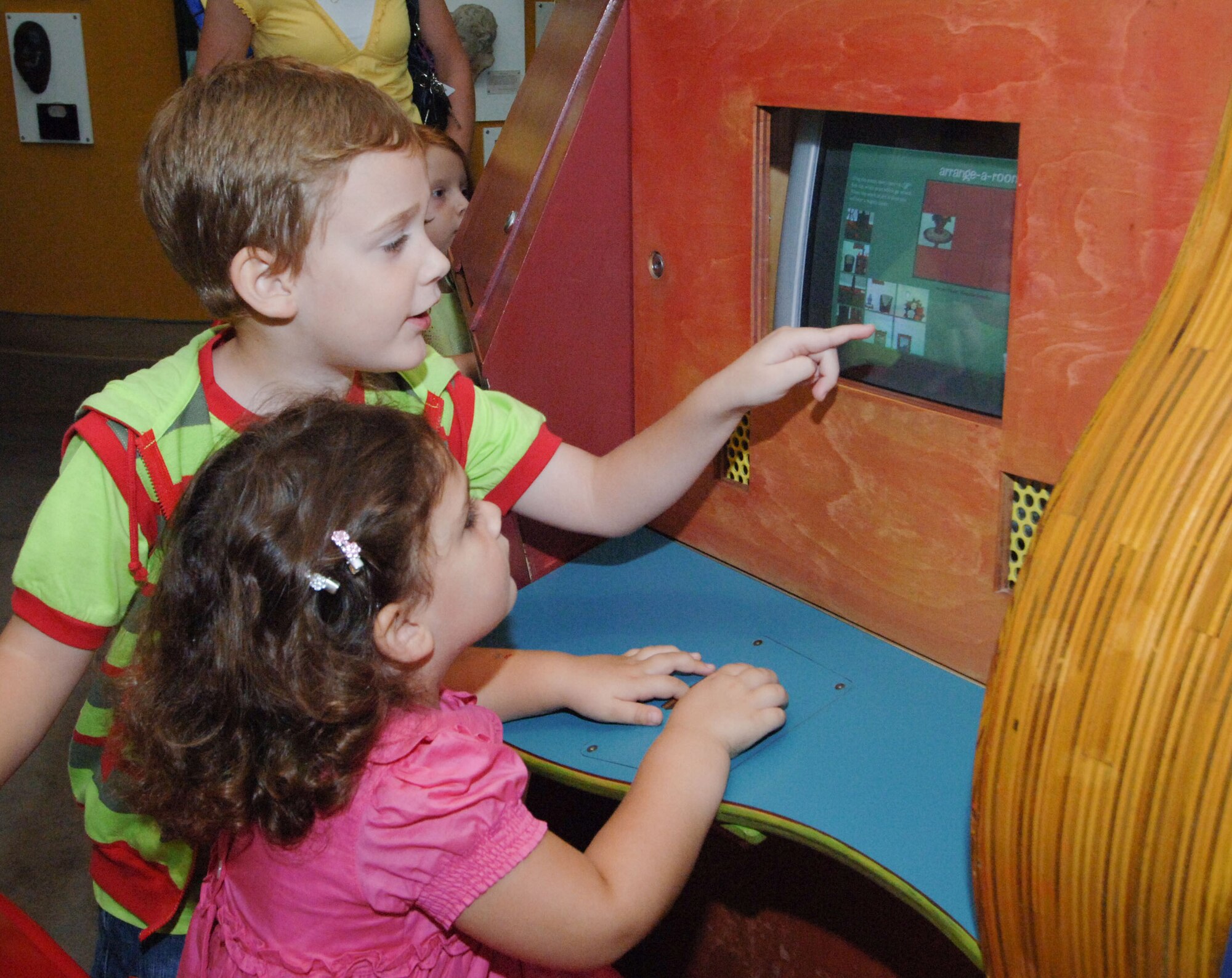 Jovan, 5, explains a hands-on exhibit to his 3-year-old sister Marina Aug. 20 at the Montgomery Museum of Fine Arts Military Appreciation Night. They are the children of Serbian Air Force Maj. Aleksandar Beara. (U.S. Air Force photo/Melanie Rodgers Cox)