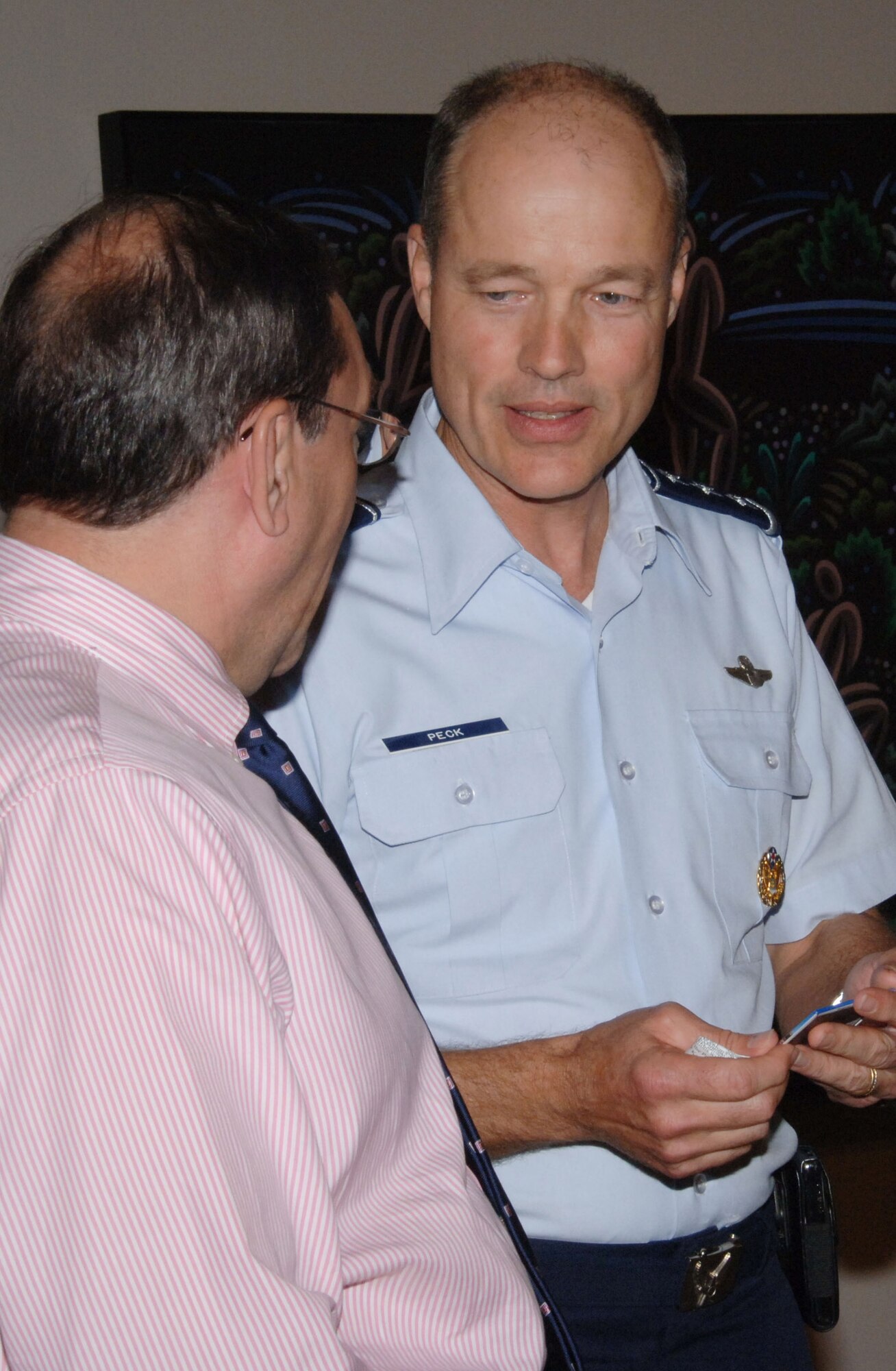 Air University Commander, Allen. G. Peck (right) talks with Mark Johnson, director of the Montgomery Museum of Fine Arts Aug. 20 at the museum's Military Appreciation Night. (U.S. Air Force photo/Melanie Rodgers Cox)