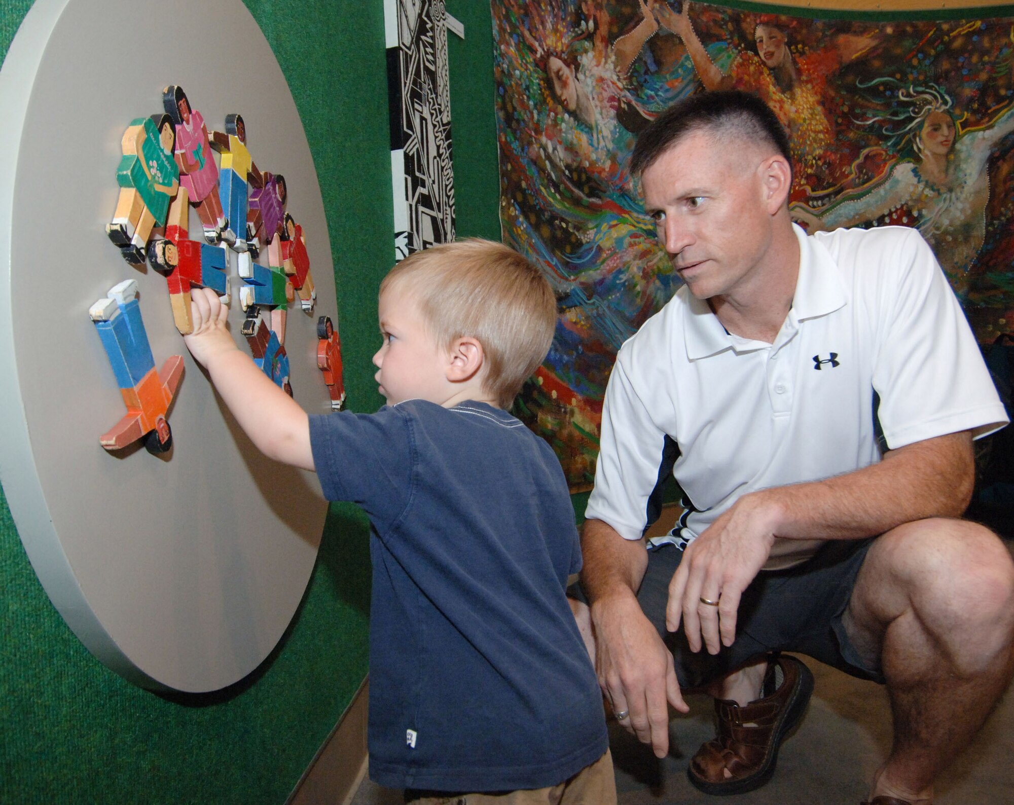 Maj. Jim Beaty, Air Command and Staff College student, and his son Emmett try out one of the interactive exhibits at the Military Appreciation Night Aug. 20 at the Montgomery Museum of Fine Arts. (U.S. Air Force photo/Melanie Rodgers Cox)