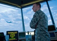 Airman 1st Class Kent Grych, 37th Operations Support Squadron, scans the flight line for other aircraft as a C-5 takes off from Lackland Air Force Base. Air traffic controllers from the 37th OSS are responsible for all movement that takes place on the Kelly Field Annex and Lackland Air Force Base flight line. (U.S. Air Force photo/Senior Airman Christopher Griffin)