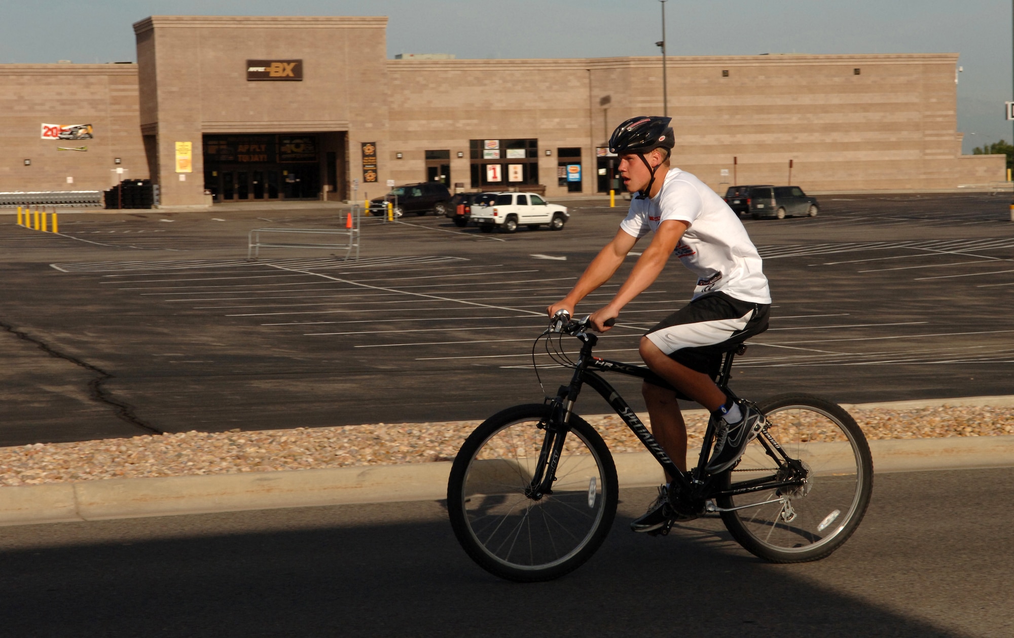 Eric Wermuth bikes past the Buckley Air Force Base Exchange Aug. 23 during the second stage of the mini-triathlon, the 12-mile bike ride. (U.S. Air Force photo by Tech. Sgt. Shirley Henderson)