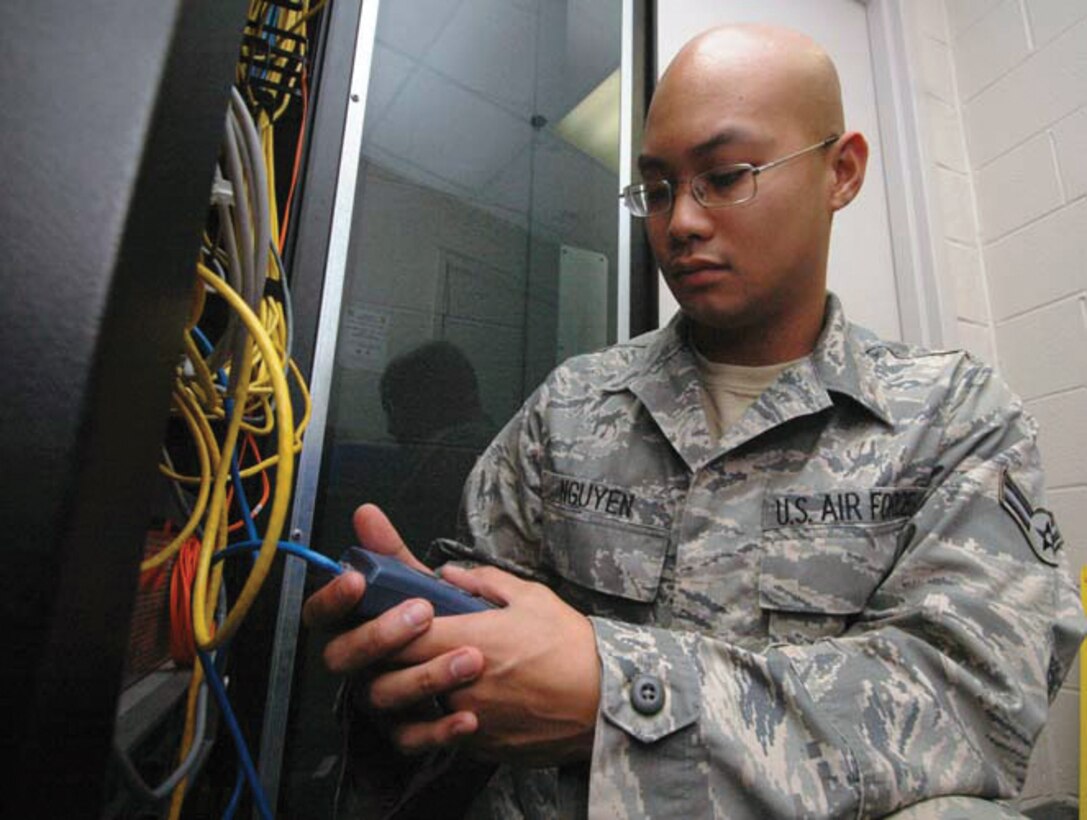 Airman 1st Class Joe Nguyen, 744th Communications Squadron network infrastructure technician, uses a fluke meter to test the consistency of cables on a CISCO Switch. On his first deployment to Afghanistan, from December 2008 to June 2009, Airman Nguyen served as the only certified Air Force MK-19 gunner for the Marine 201st 3rd Brigade. (U.S. Air Force photo/ Bobby Jones)