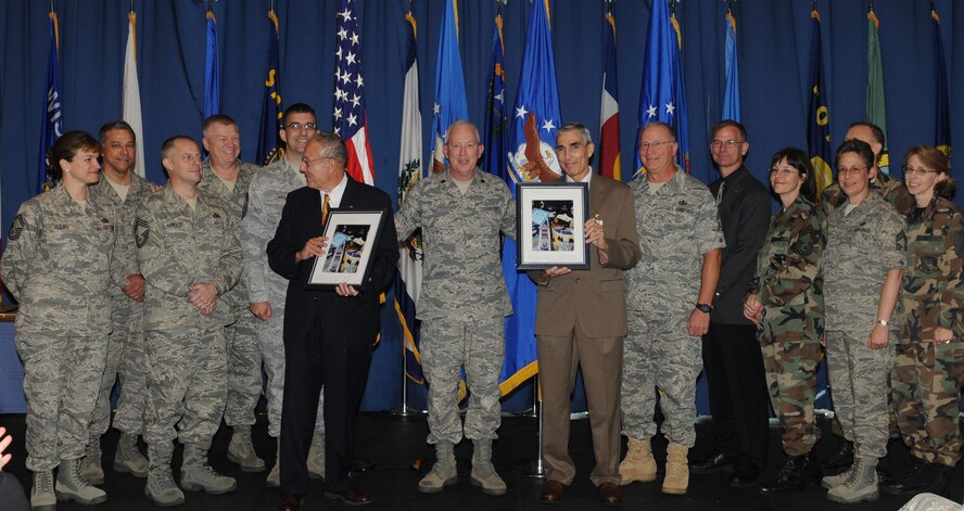 Lt. Col. Alan Sierichs, United States Air Force Band commander, and both current and past chief master sergeants from the Air Force Band, gather to present John Sterle and Timothy Compton with their retirement gifts Aug. 27 in the Honor Guard Ceremonial Hall. Mr. Sterle and Mr. Compton are retired chiefs from the Air Force Band and continued working with the Band and the Honor Guard as schedulers after their retirement from active duty military service. 