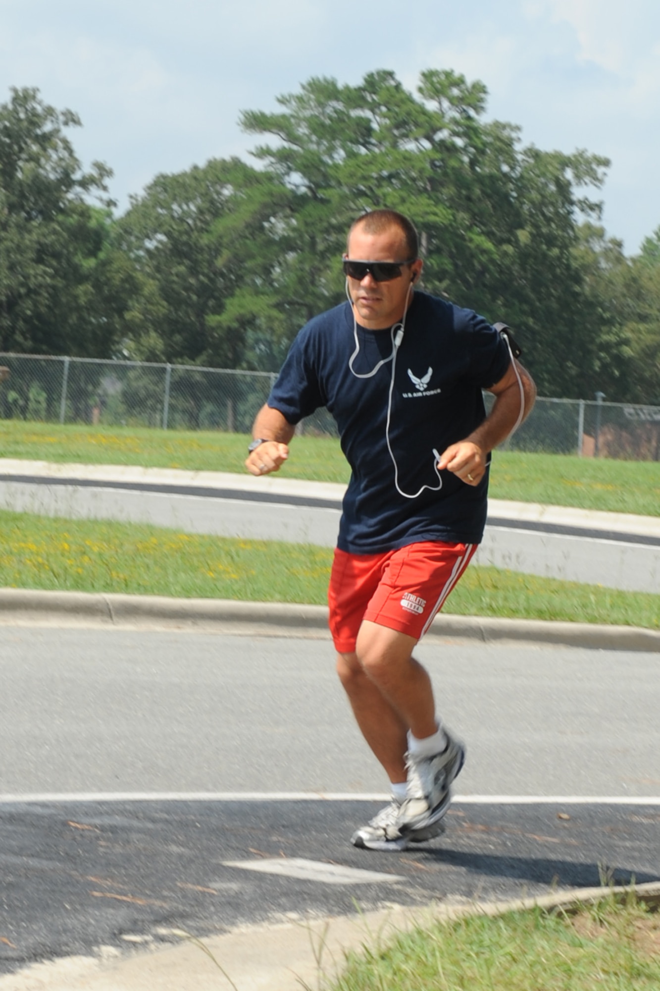 Tech. Sgt. Daniel Ruffino, 4th Equipment Maintenance Squadron fitness program manager, runs along the two-mile golf course trail at Seymour Johnson Air Force Base, N.C., Aug. 24, 2009. As a FPM, Sergeant Ruffino works hand-in-hand with the Health and Wellness Center staff to help Airmen struggling with weight and fitness issues to turn unhealthy habits around. The HAWC staff offers a number of free wellness classes to help members of the Seymour Johnson community battle creeping waistlines. (U.S. Air Force photo by Airman 1st Class Whitney Lambert)