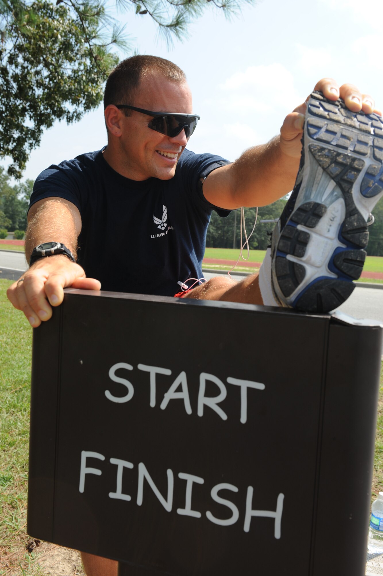 Tech. Sgt. Daniel Ruffino, 4th Equipment Maintenance Squadron fitness program manager, stretches before running the two-mile golf course trail at Seymour Johnson Air Force Base, N.C., Aug. 24, 2009. Sergeant Ruffino encourages Airmen struggling with their weight or fitness to use an online calorie and exercise log. (U.S. Air Force photo by Airman 1st Class Whitney Lambert)