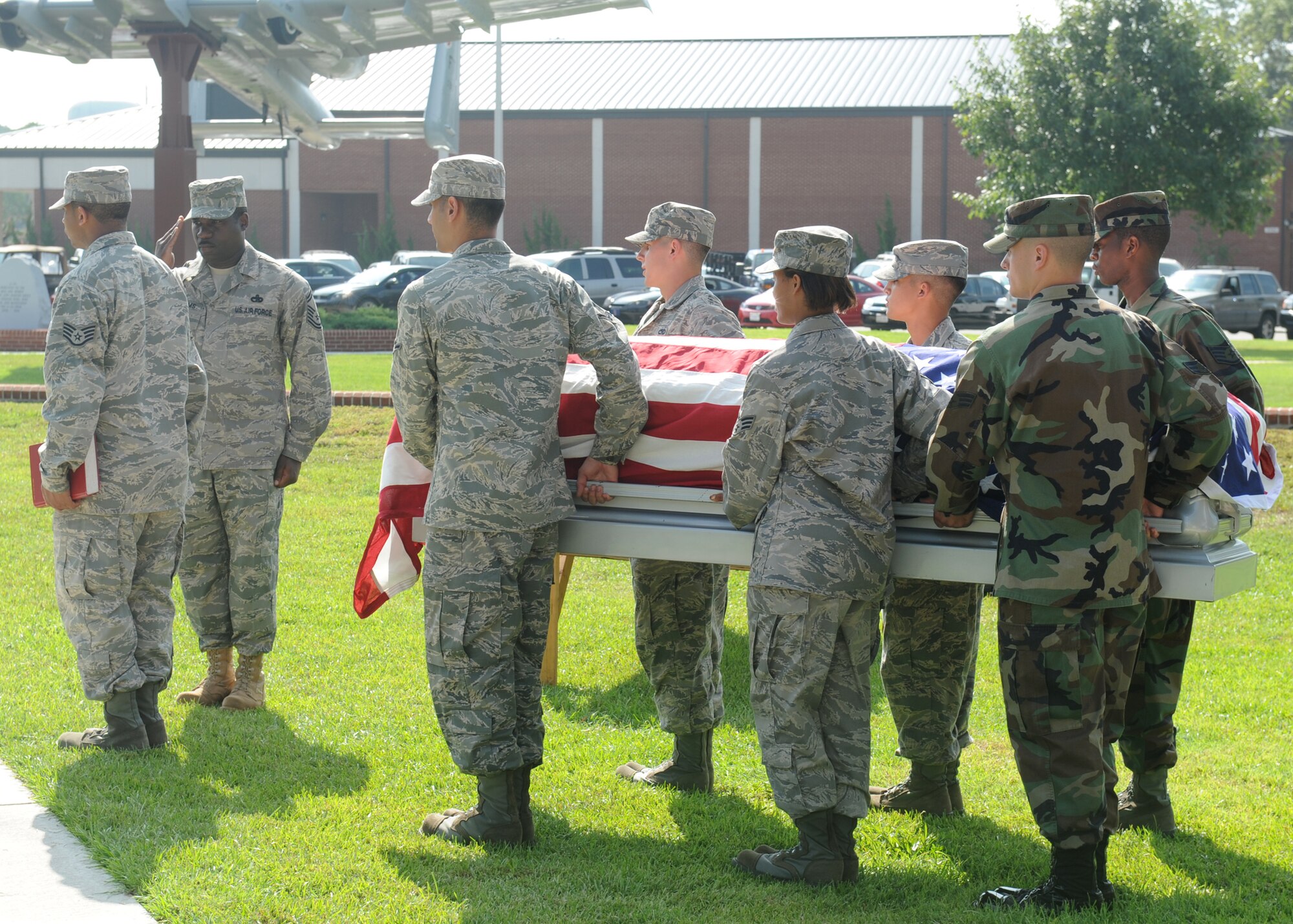 Senior Master Sgt. Marcus Williams, Charlotte Air National Guard, salutes the flag while the pallbearers carry a mock casket during the honor guard graduation ceremony at Seymour Johnson Air Force Base, N.C., Aug. 19, 2009. The 4th Fighter Wing honor guard travels throughout North Carolina and parts of Virginia and South Carolina performing military honors. (U.S. Air Force photo by Airman 1st Class Whitney Lambert)