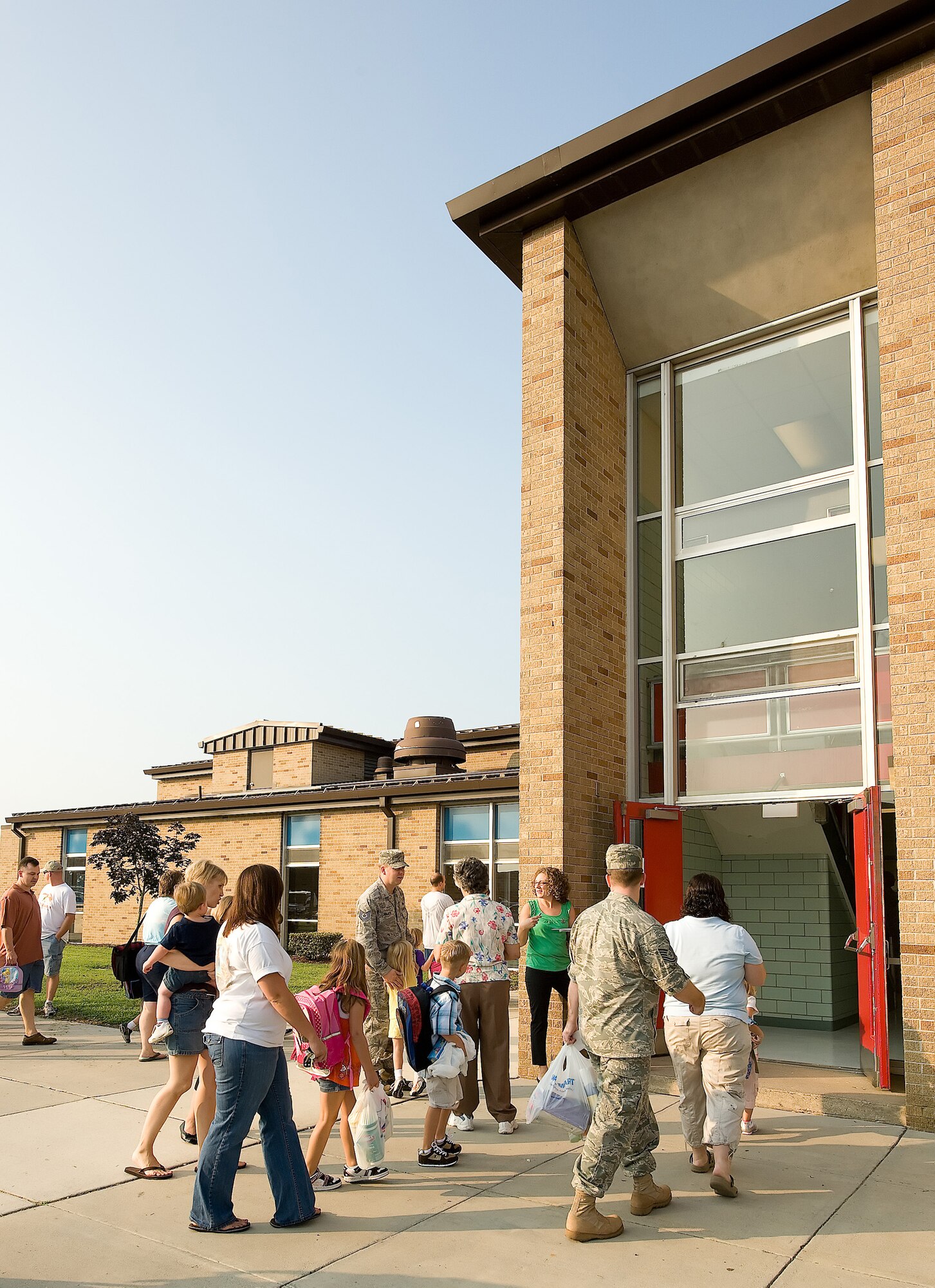 Parents and their children enter George S. Welch Elementary School Aug. 26 for the first day of class. With the start of the new school year, drivers should pay close attention to school zones and pedestrians, as many children in base housing walk to school. (U.S. Air Force photo/Jason Minto) 