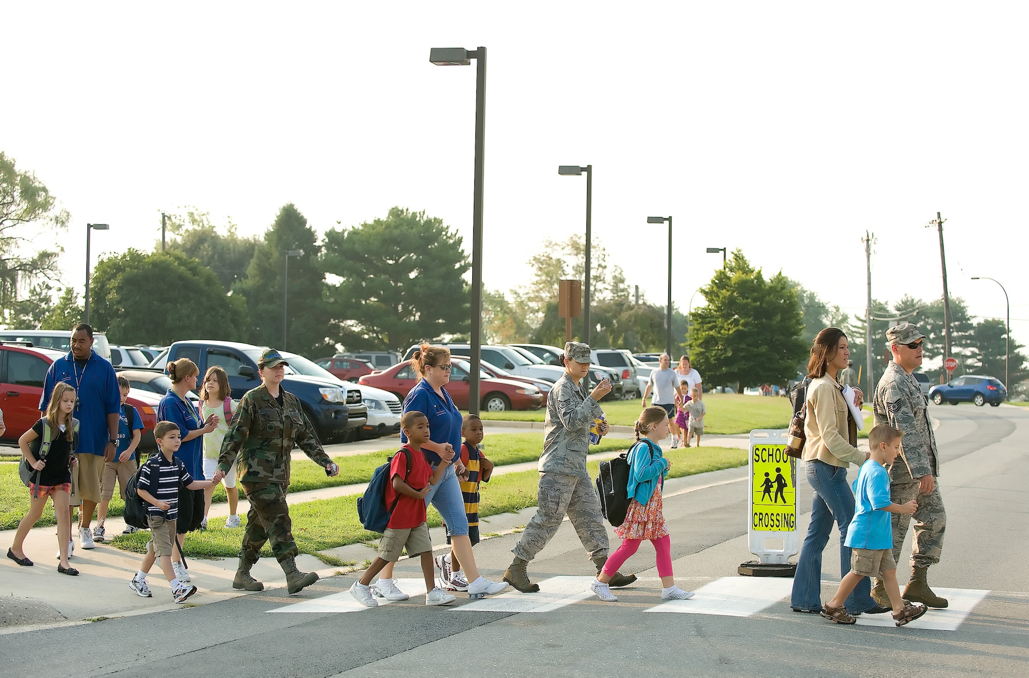 Parents help their children cross the street for the first day of school Aug. 26. Students started classes at both schools in base housing, George S. Welch Elementary School and Dover Air Base Middle School. (U.S. Air Force photo/Jason Minto)