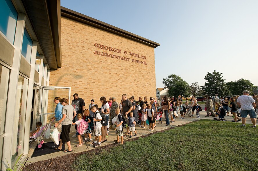 Children line up with their parents to enter George S. Welch Elementary School for the first day of school Aug. 26. With the start of the new school year, drivers should be more alert for pedestrians as many children walk or bike to school. (U.S. Air Force photo/Jason Minto)