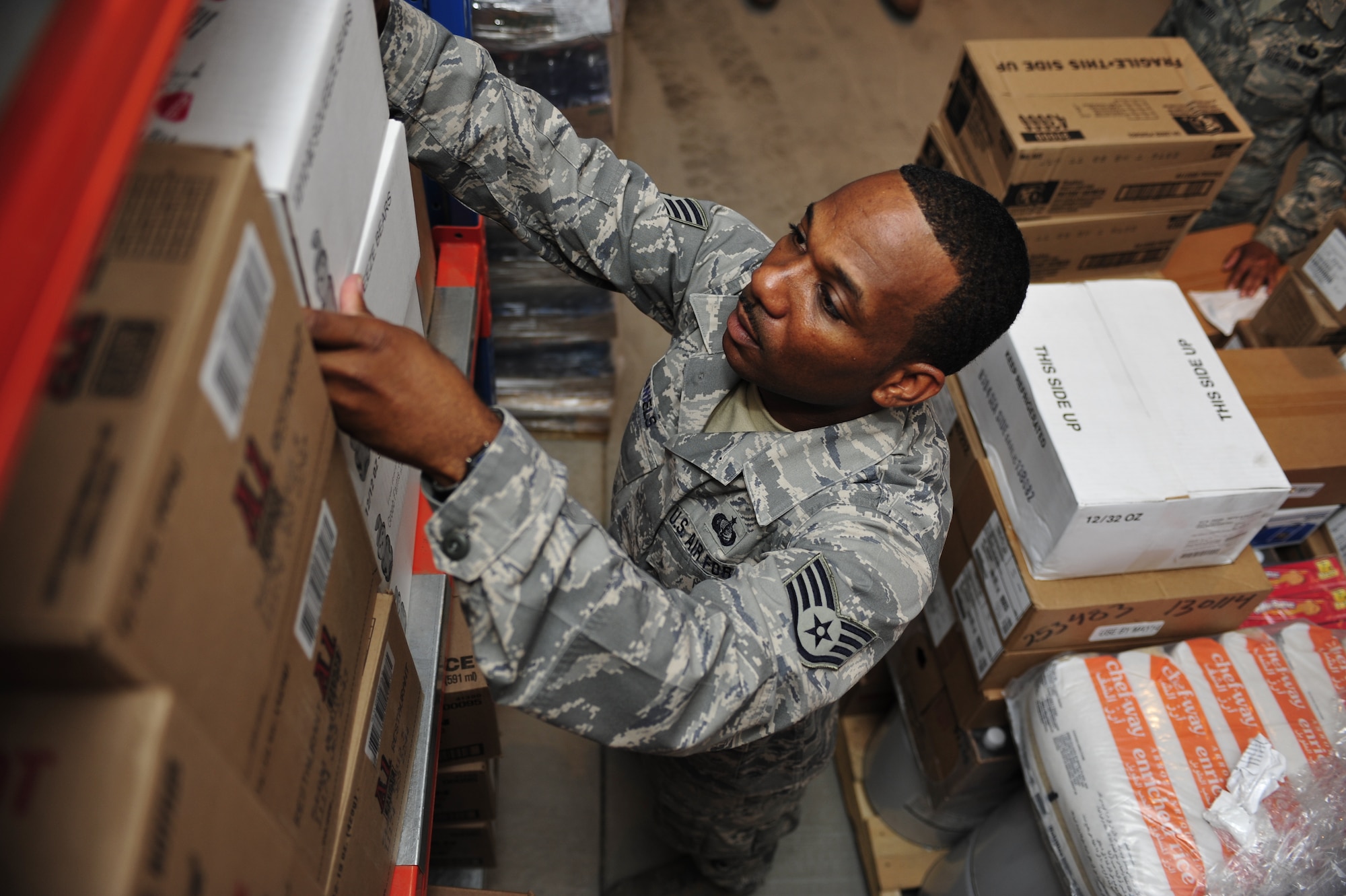 SOUTHWEST ASIA -Staff Sgt. Marvin Daniels, 380th Expeditionary Force Support Squadron, restocks food supplies in the flight line storage room Aug. 21. Sergeant Daniels is deployed from the 187th Fighter Wing, and grew up in Montgomery, Ala. (U.S. Air Force photo/Tech. Sgt. Charles Larkin Sr)