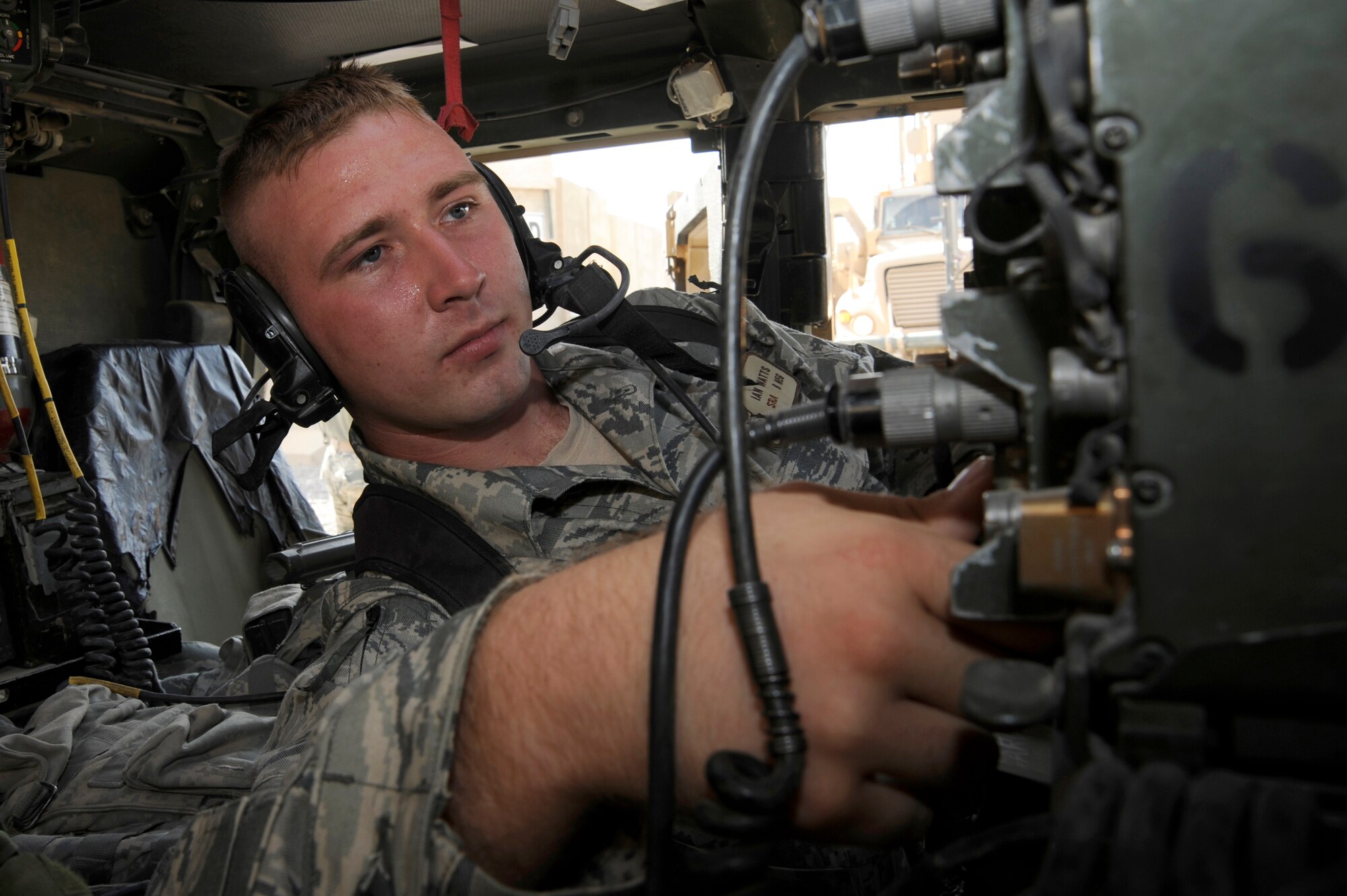 CAMP STRYKER, Iraq -- Air Force Senior Airman Ian Watts, 732nd Expeditionary Security Forces Squadron Detachment 2 Police Transition Team, performs radio checks in his Humvee here Aug. 22, 2009. The checks ensure he will be able to communicate with other vehicles on his security team. The 732nd ESFS provides outside-the-wire combat support by training Iraqi policemen and performing intelligence operations to enhance the security of the country. Airman Watts is deployed from Langley Air Force Base, Va., and is a native of Big Timber, Mont.  (U.S. Air Force photo/Tech. Sgt. Johnny L. Saldivar)