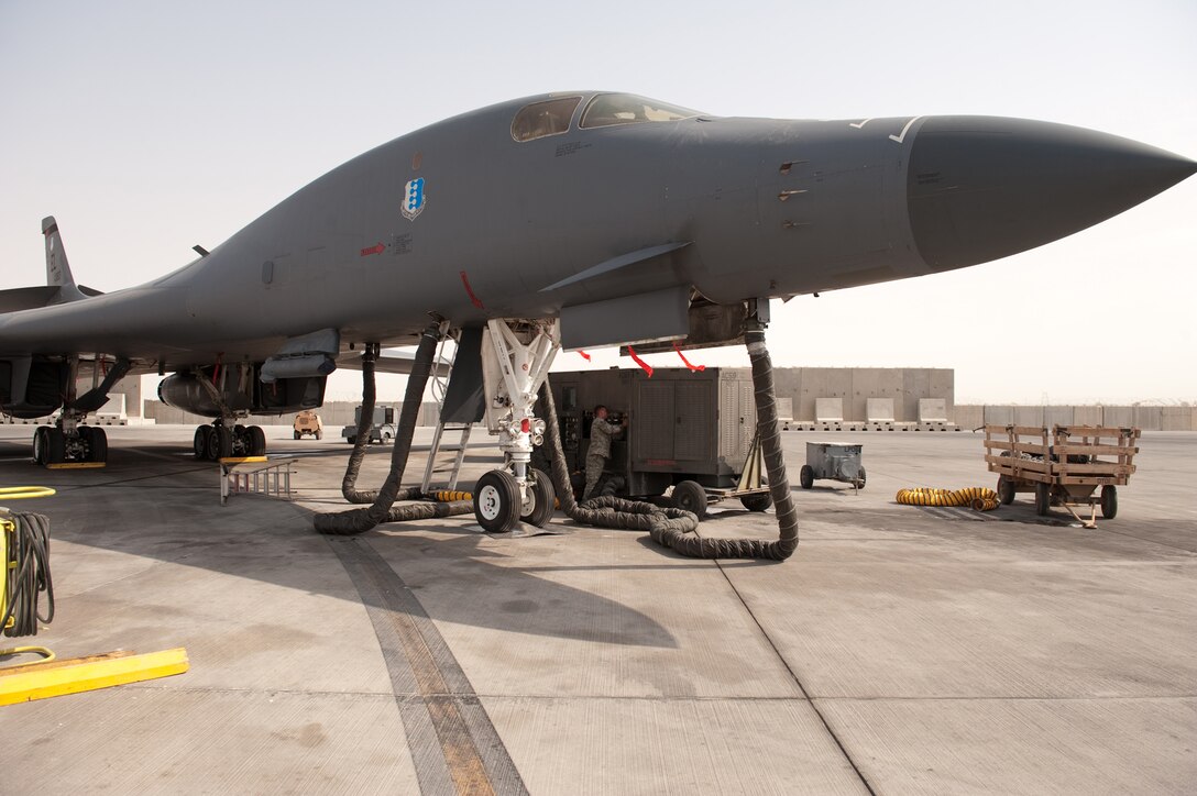 Tech. Sgt. Jesse Maddox, 379th Expeditionary Maintenance Squadron metals technology floor supervisor, installs a splitter on an air conditioner unit, Aug. 26, in Southwest Asia. Sergeant Maddox, along with his co-workers, designed and manufactured a custom splitter that limits the number of AC units supporting a B-1B Lancer from multiple units down to a single AC unit. Sergeant Maddox is a native of Clearwater, Fla. and is deployed from Ellsworth Air Force Base, S.D.  in support of Operations Iraqi and Enduring Freedom.  (U.S. Air Force photo/Staff Sgt. Robert Barney)
