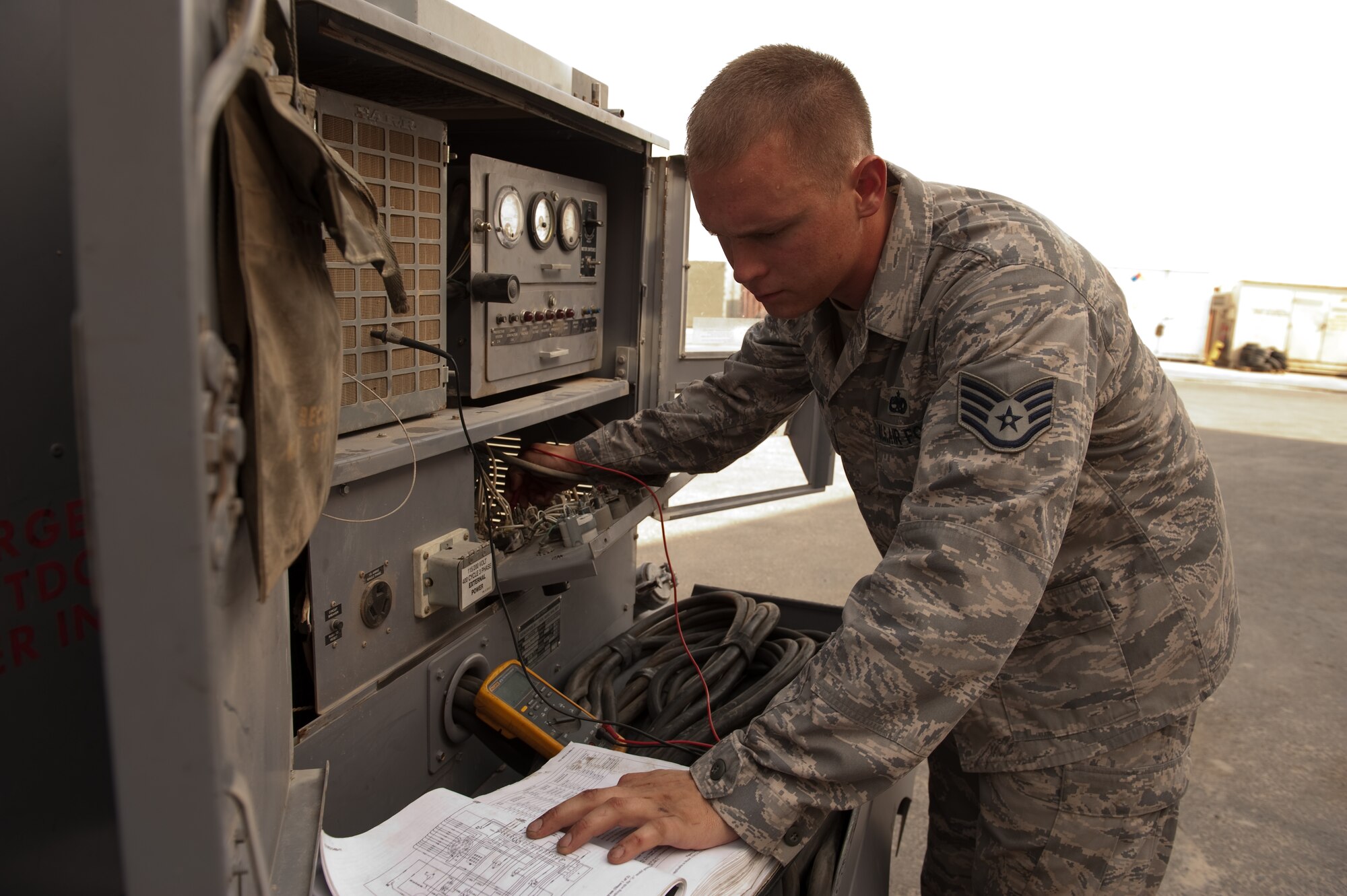 Staff Sgt. Phillip Piddington, 379th Expeditionary Maintenance Squadron air and ground equipment craftsman, performs a voltage check on a diesel generator, Aug. 24, in Southwest Asia. Airmen assigned to 379 EMXS AGE section provide the various ground and support equipment required by aircraft maintainers and inspectors. Sergeant Piddington is a native of Galesville, Wis. and is deployed from MacDill Air Force Base, Fla. in support of Operations Iraqi and Enduring Freedom. (U.S. Air Force photo/Staff Sgt. Robert Barney)