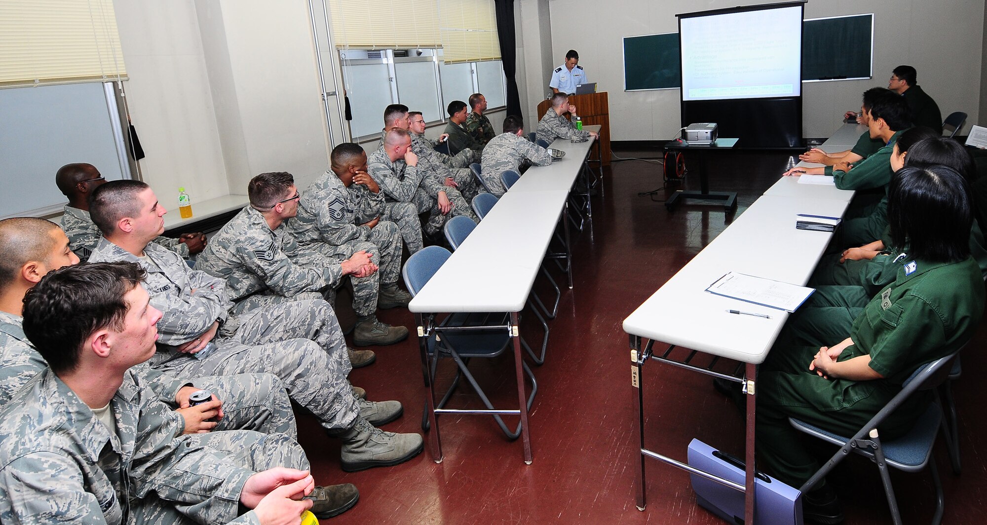 KOMAKI AIR BASE, Japan -- Airmen from the 374th Airlift Wing receive a briefing from Japan Air Self-Defense Force members during a Bilateral Airlift Training Program visit Aug. 26. The program is designed to enhance interoperability, build working relationships, and explore joint training/operations opportunities. During the visit, Yokota Airmen flew aboard two JASDF C-130s while maintainers toured the base's ground facilities. (U.S. Air Force photo/Airman 1st Class Sean Martin)